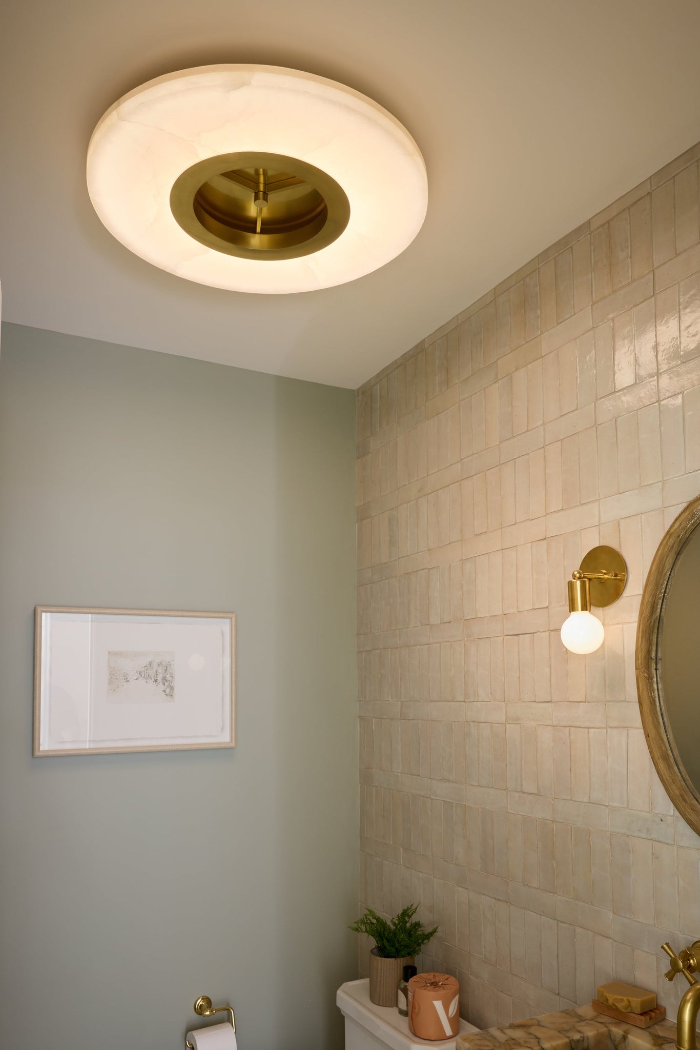 Alto Semi Flush in aged brass styled in an entryway for warm, layered light at Laurie Yapp Home.