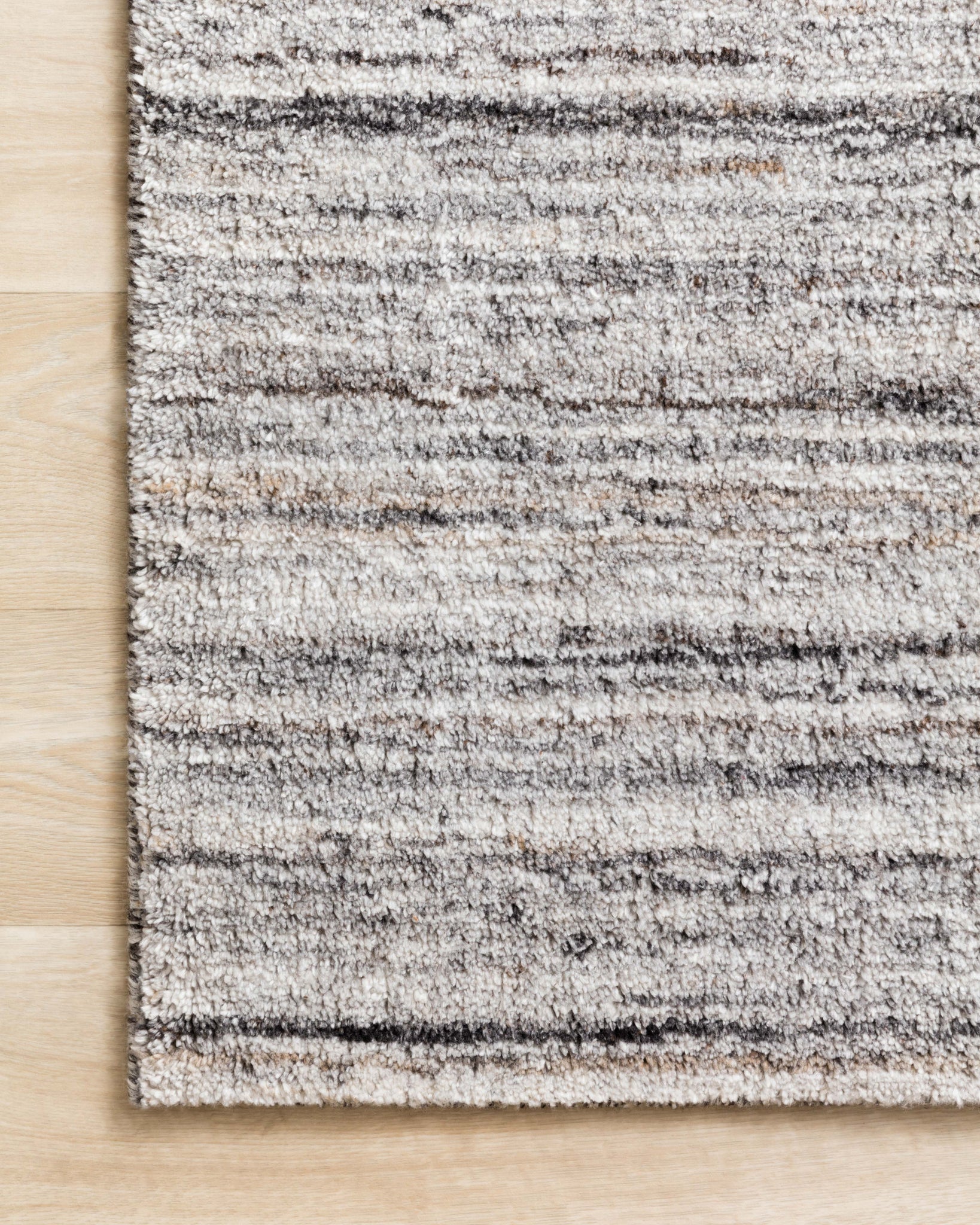 side view of Brandt Silver / Stone luxury Rug