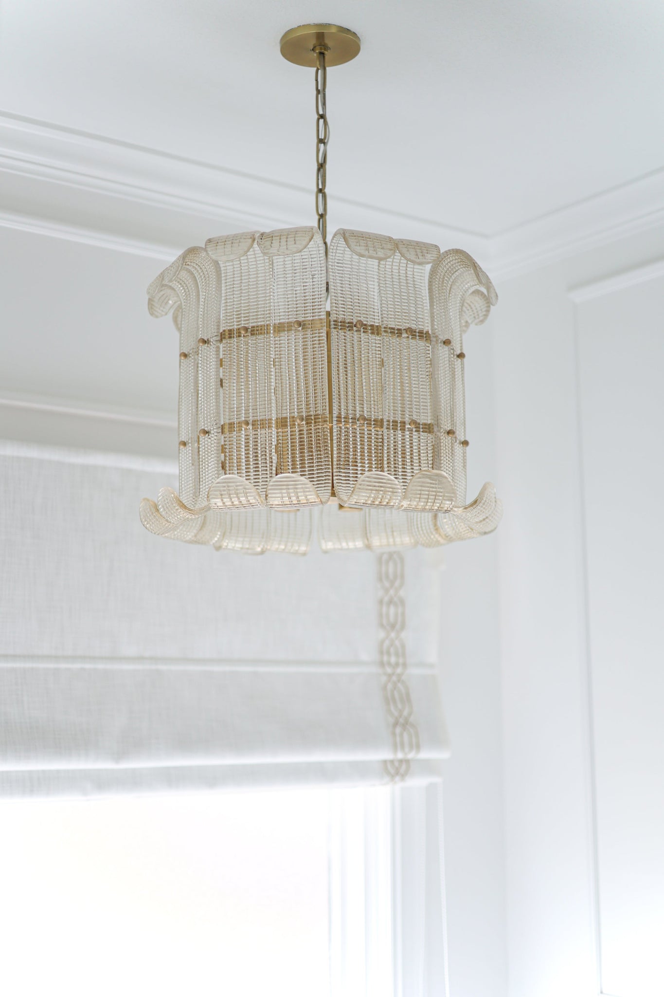 Brasher Chandelier in aged brass styled in an elegant dining room for warm, layered light at Laurie Yapp Home.