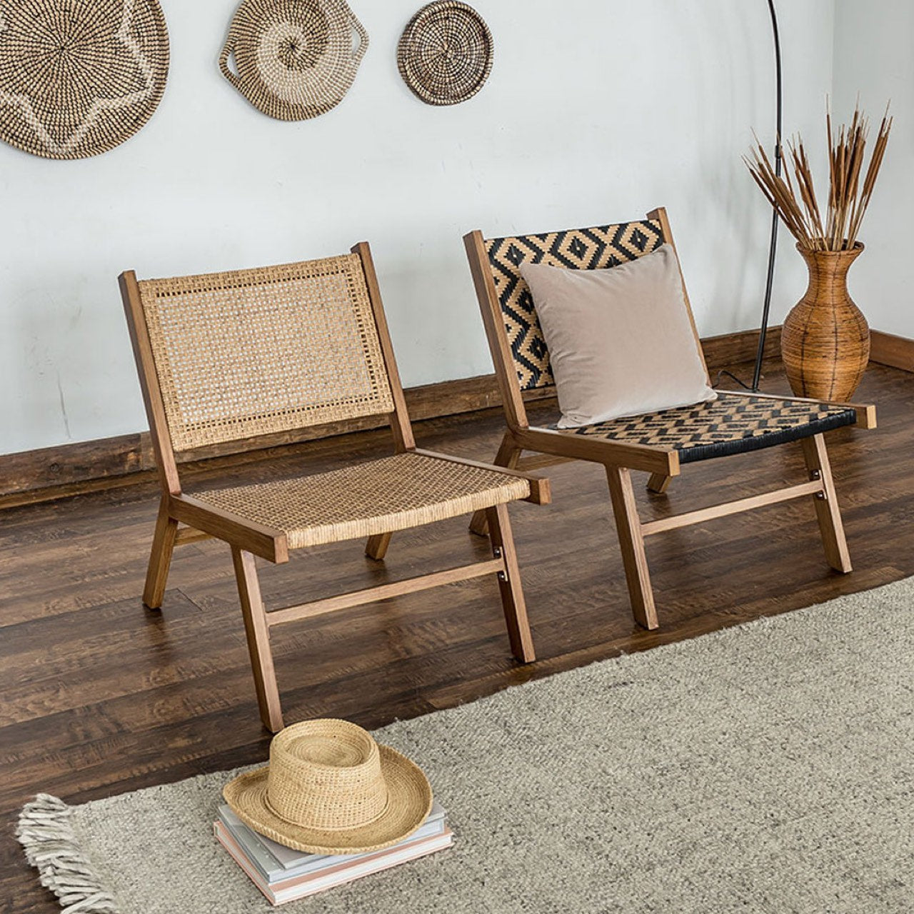 Two wooden chairs with woven backrests in a room with a hat and books on the floor.