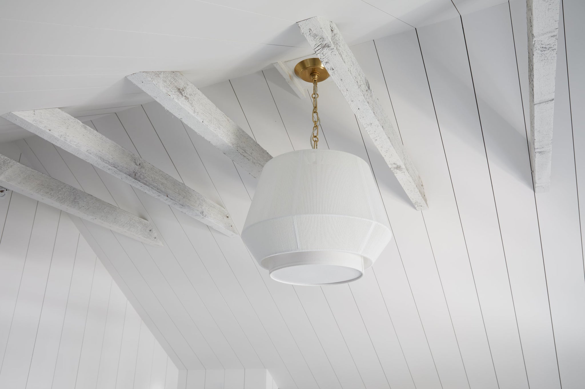 Debi Pendant 18" in aged brass styled in a bright kitchen for warm, layered light at Laurie Yapp Home.