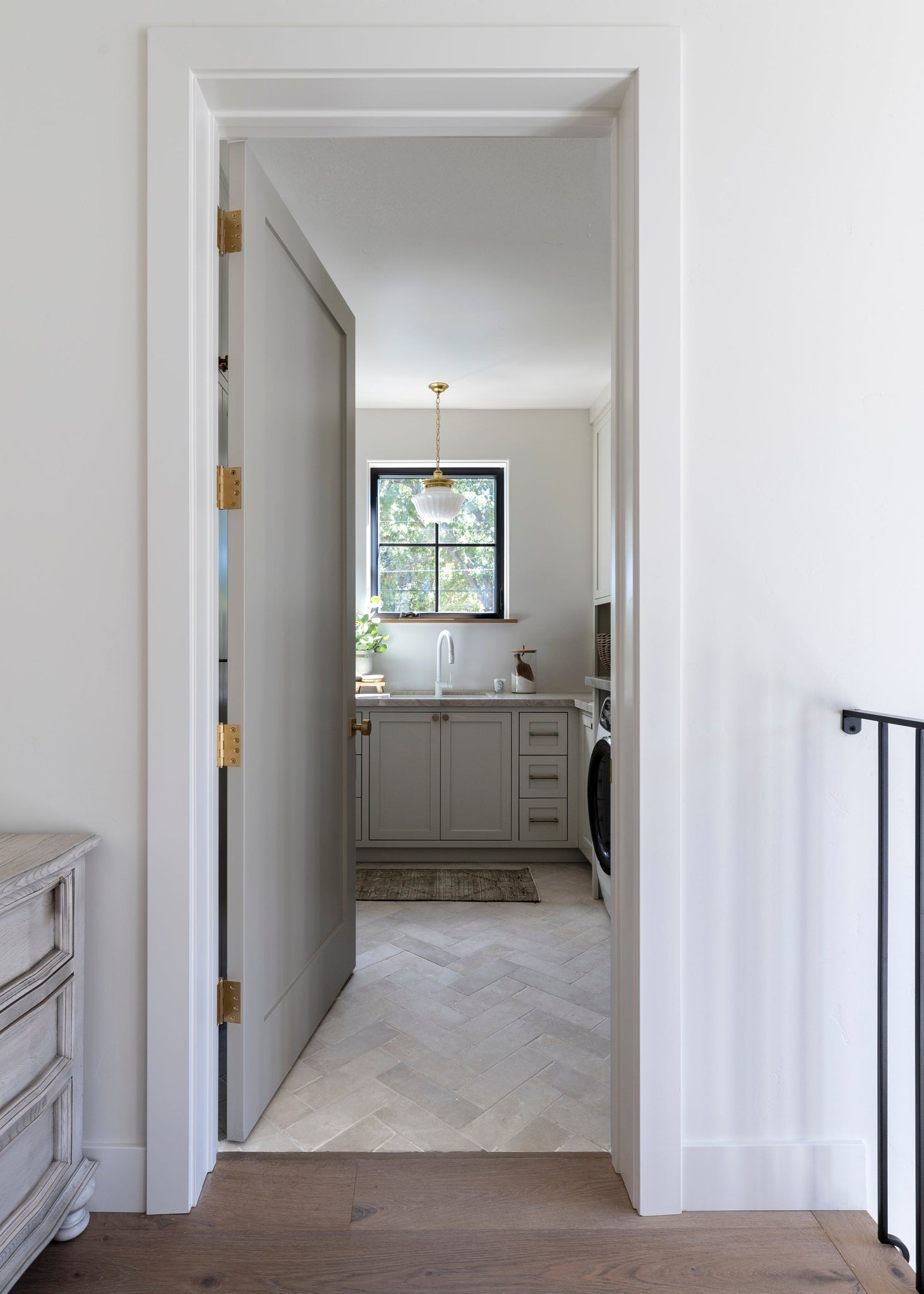 Dutchess Pendant 12" in aged brass styled in a welcoming entryway for warm, layered light at Laurie Yapp Home.