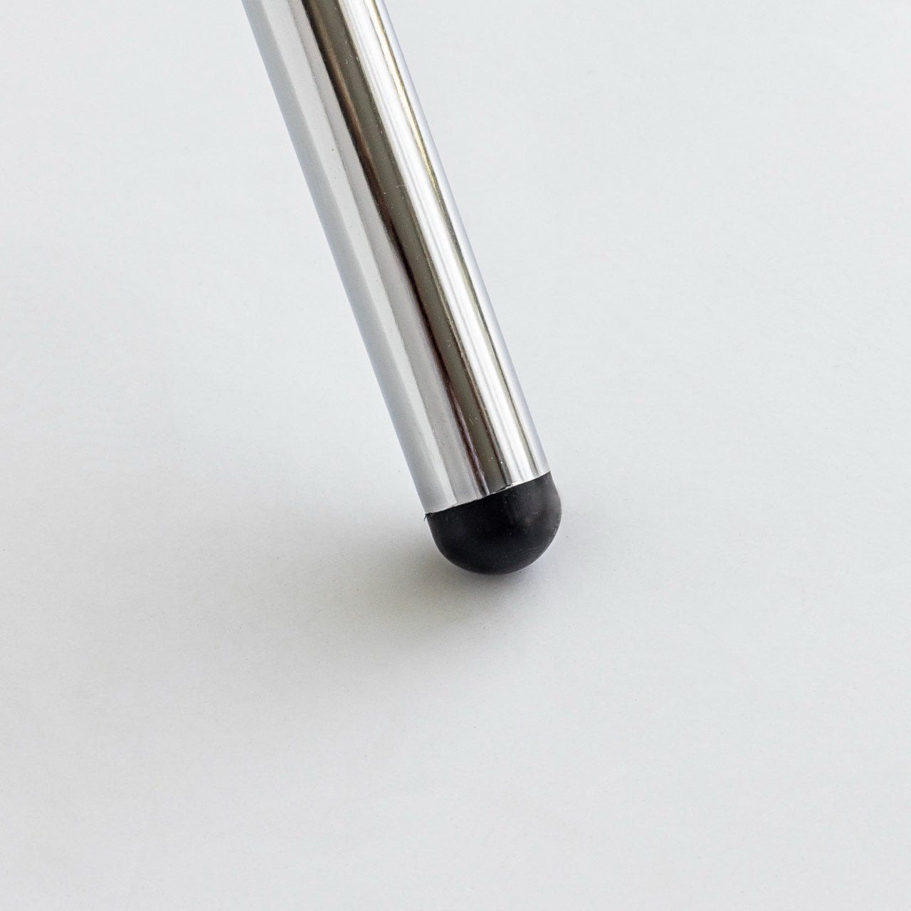 Silver stylus with black tip on a white background