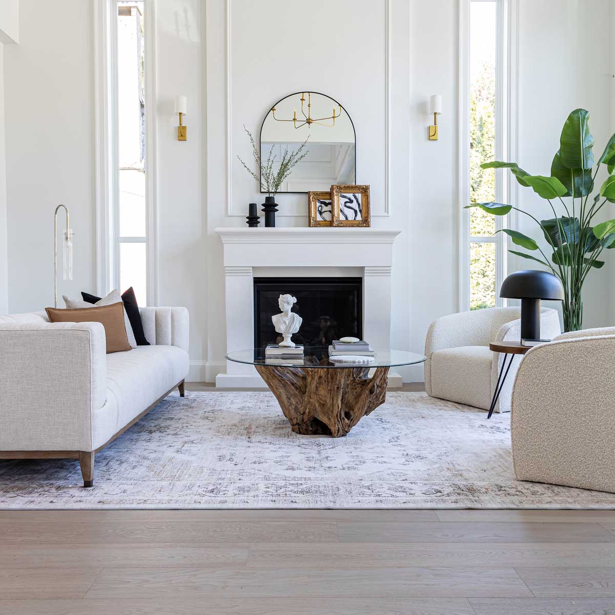 Modern living room with white walls, a fireplace, and decorative elements.