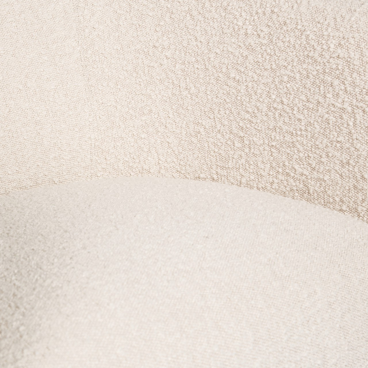 Close-up of a textured fabric with a gradient from beige to white.