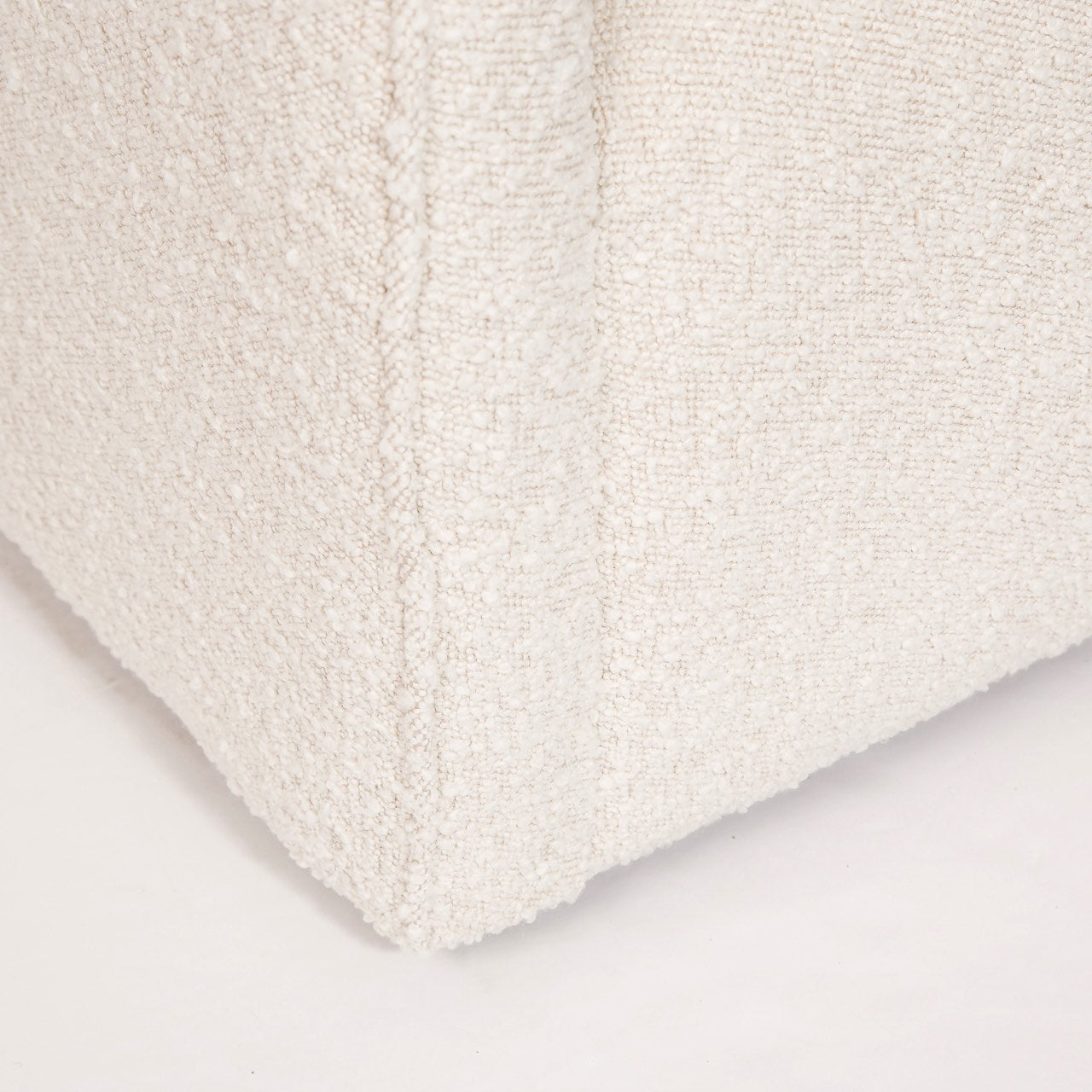 Close-up of a textured white fabric on a light gray background