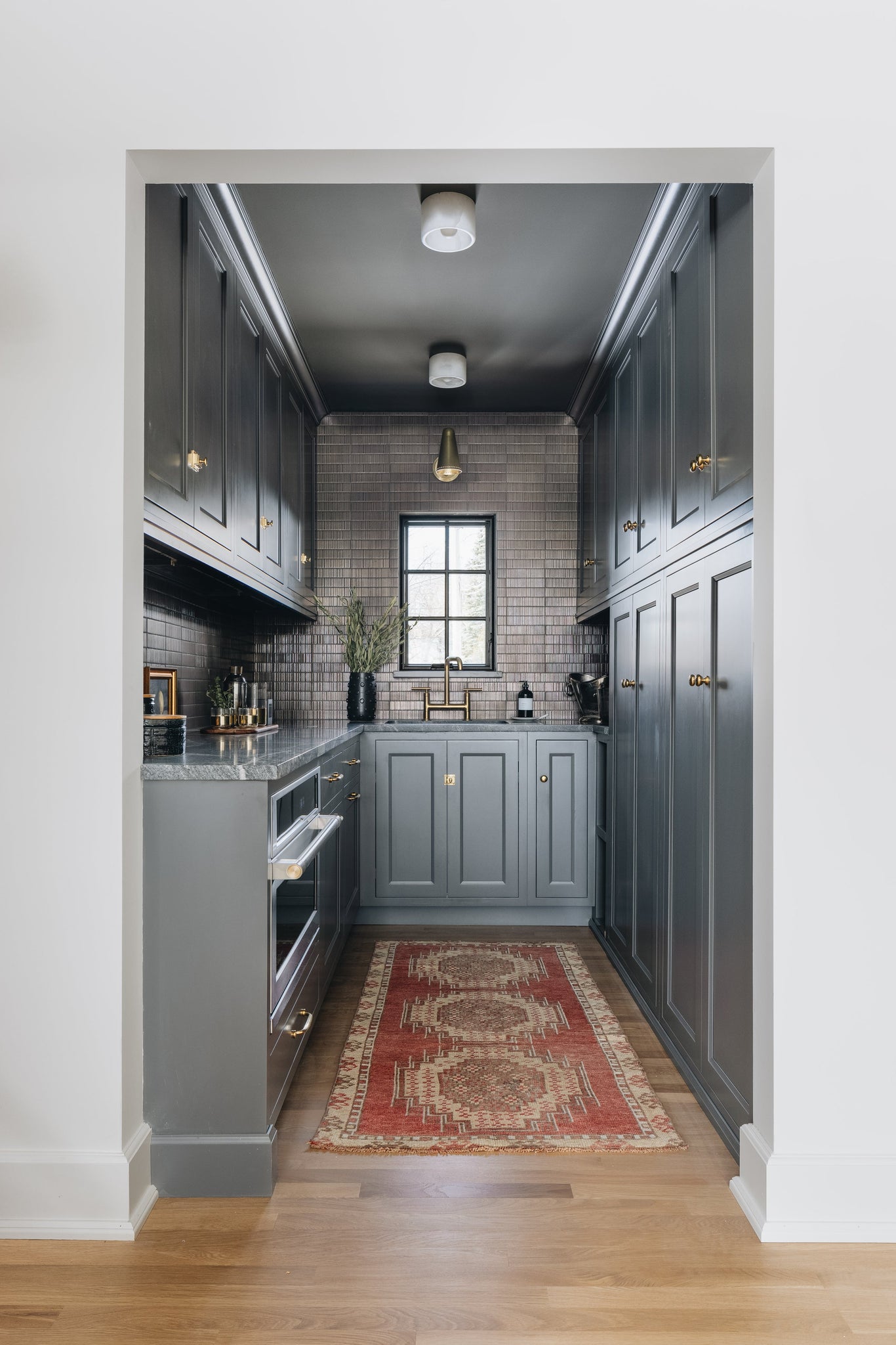 Loris Flush Mount in aged brass styled in an entryway for warm, layered light at Laurie Yapp Home.