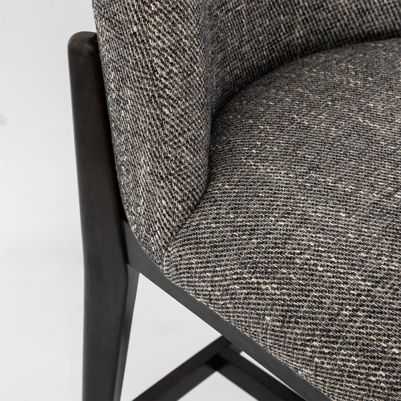 Close-up of a gray textured chair with a black metal frame on a light gray background
