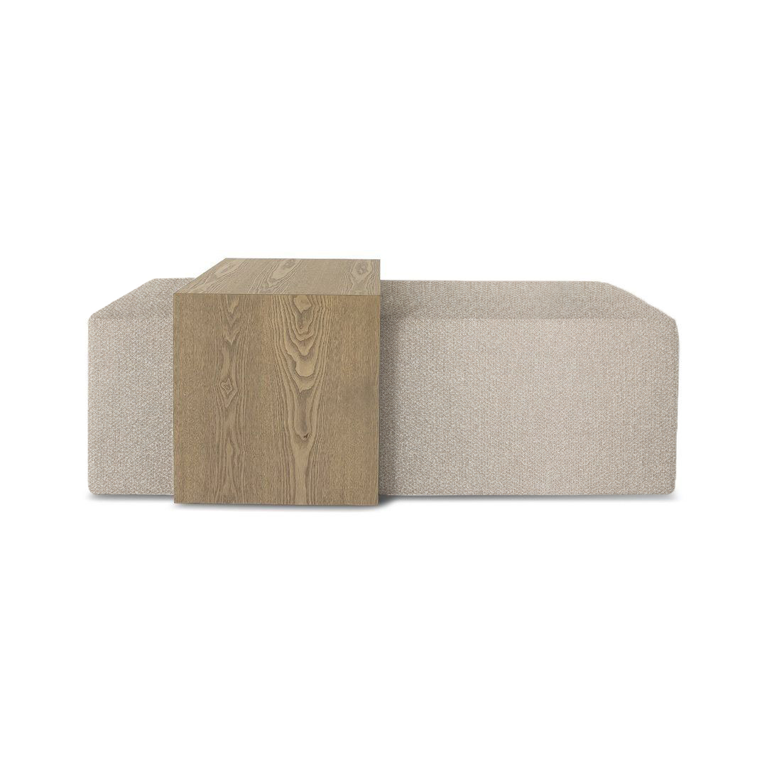 A wood coffee table and ottoman, one wooden and one upholstered, on a white background.