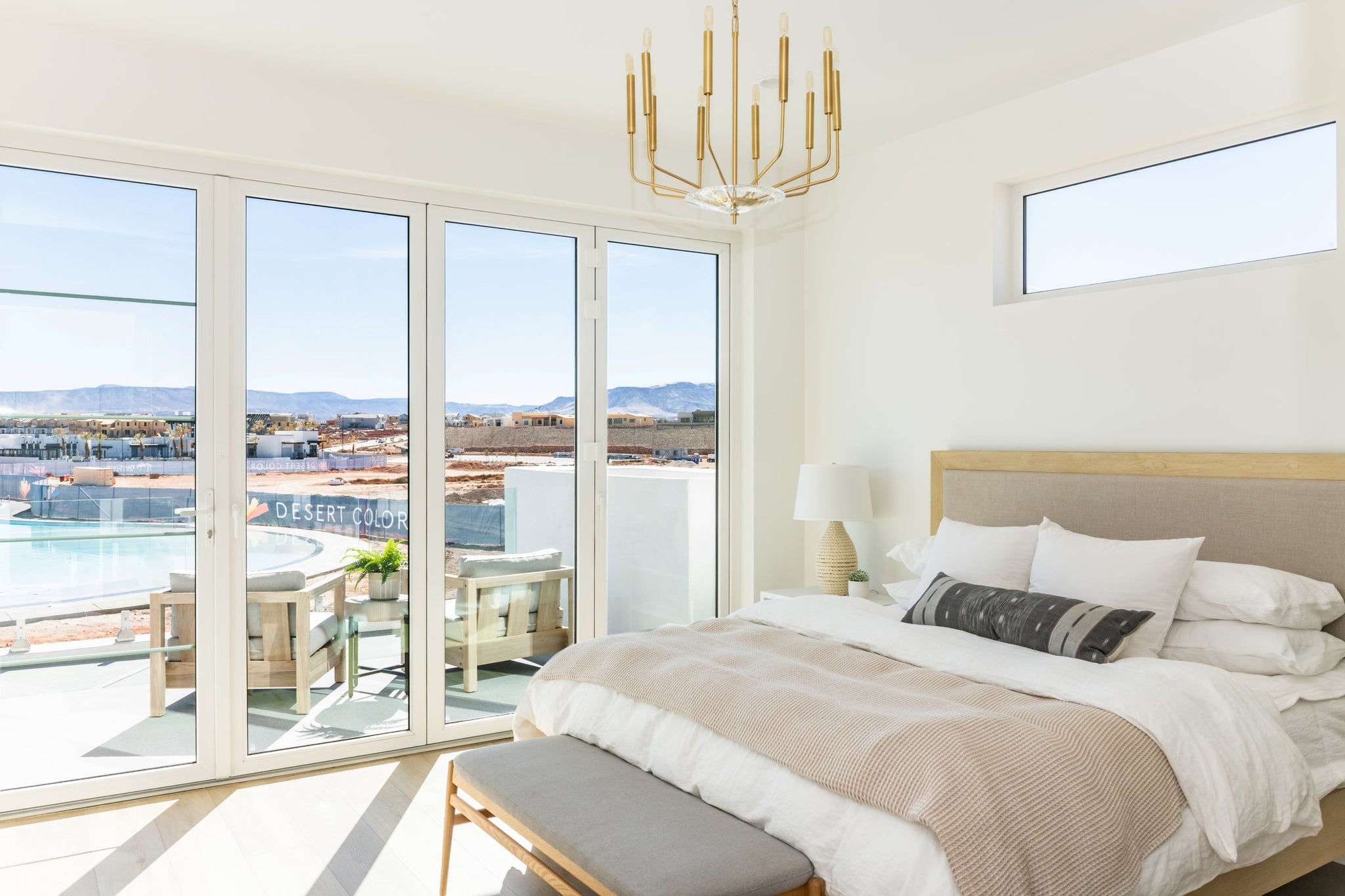 Gideon Chandelier 24.25" in aged brass styled in a two-story entry for warm, layered light at Laurie Yapp Home.