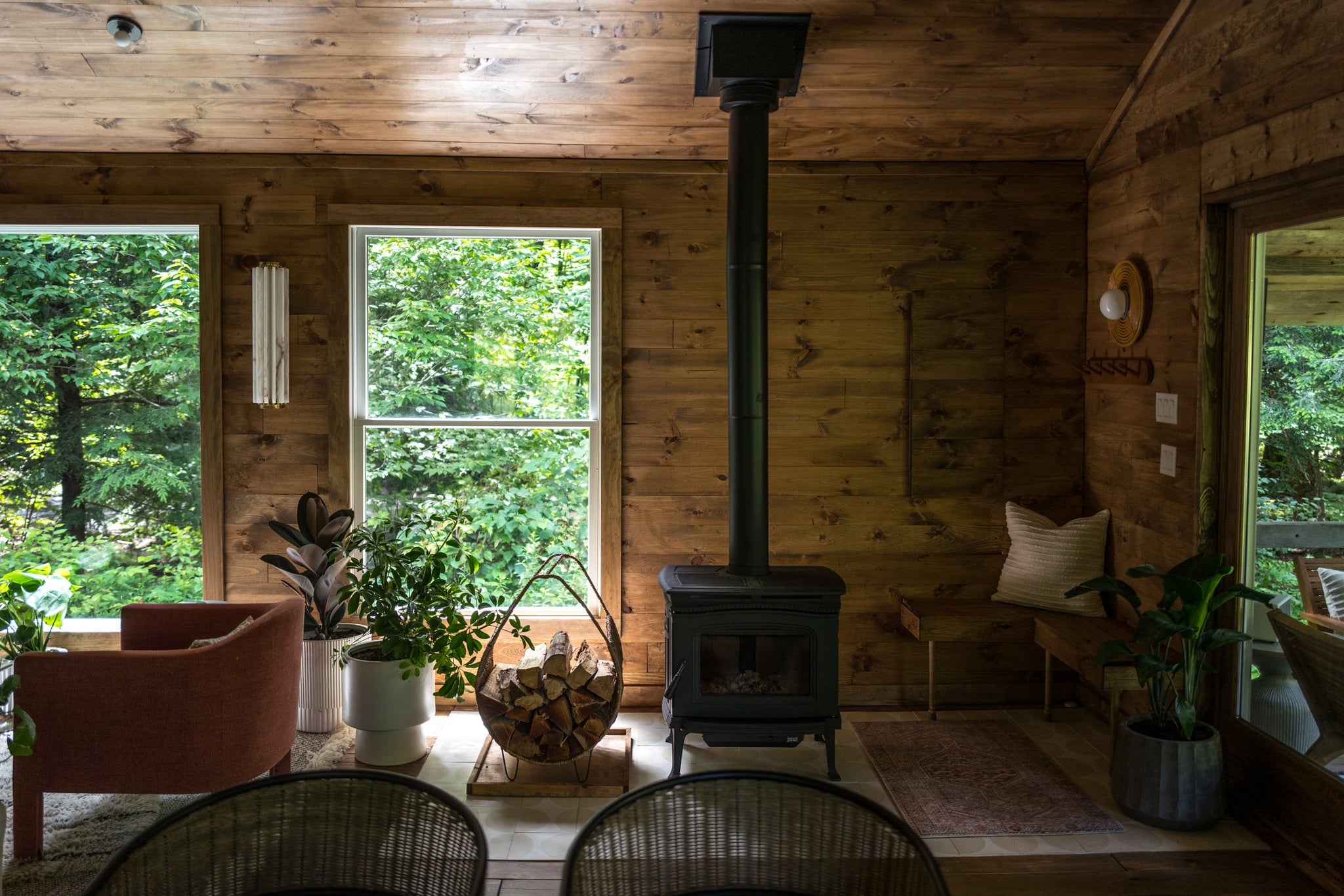 Hillside Wall Sconce 6" x 24.5" in aged brass styled in a curated living room for warm, layered light at Laurie Yapp Home.