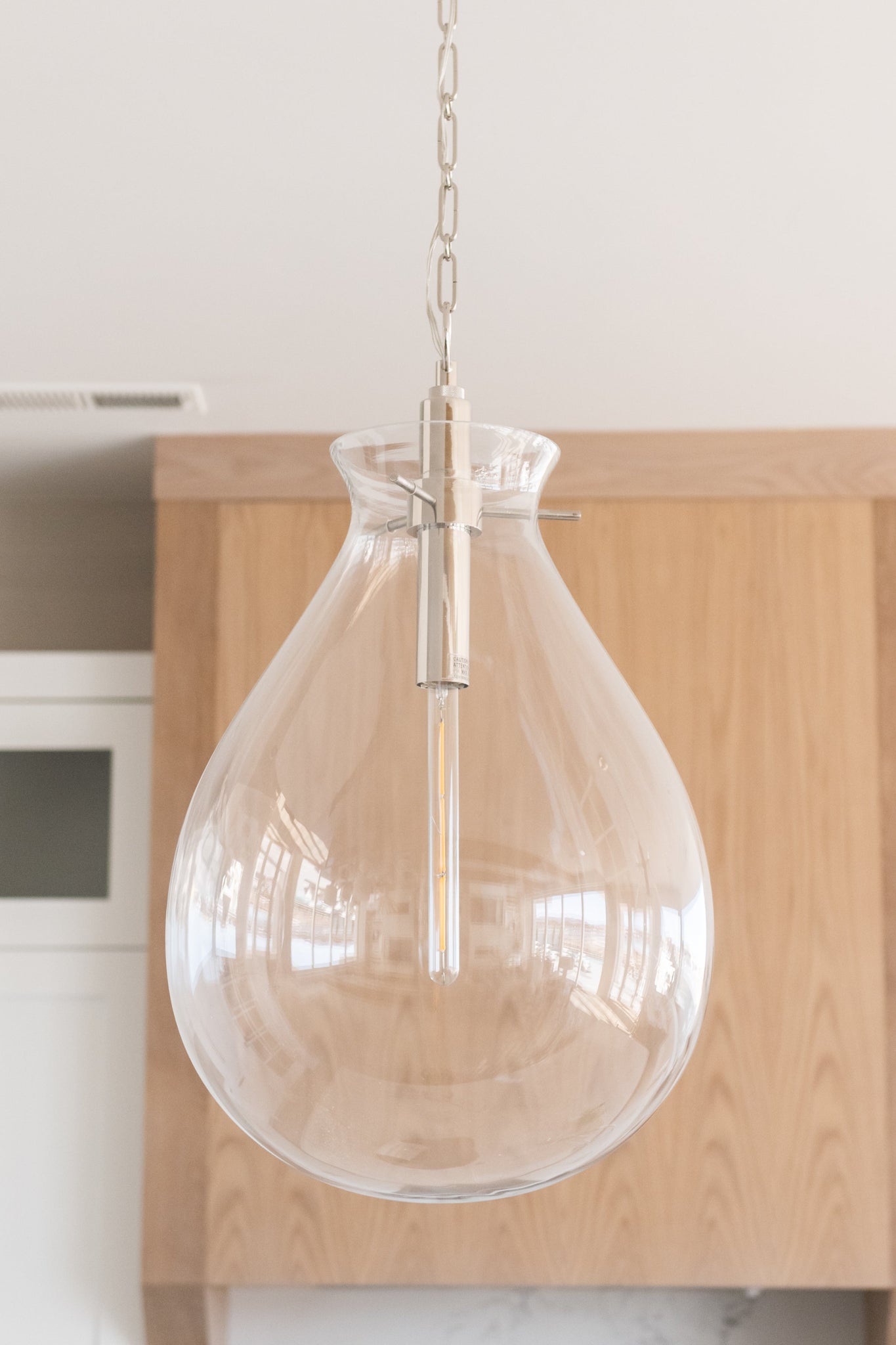 Ivy Pendant 18" in polished nickel styled in a bright kitchen for warm, layered light at Laurie Yapp Home.