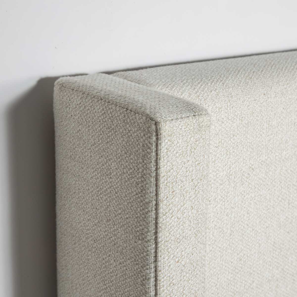 Close-up of a textured fabric surface with a neutral color palette.