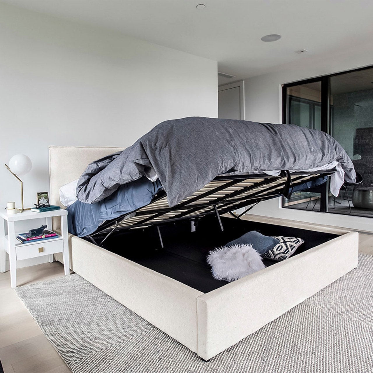 White bed with storage compartment in a modern bedroom