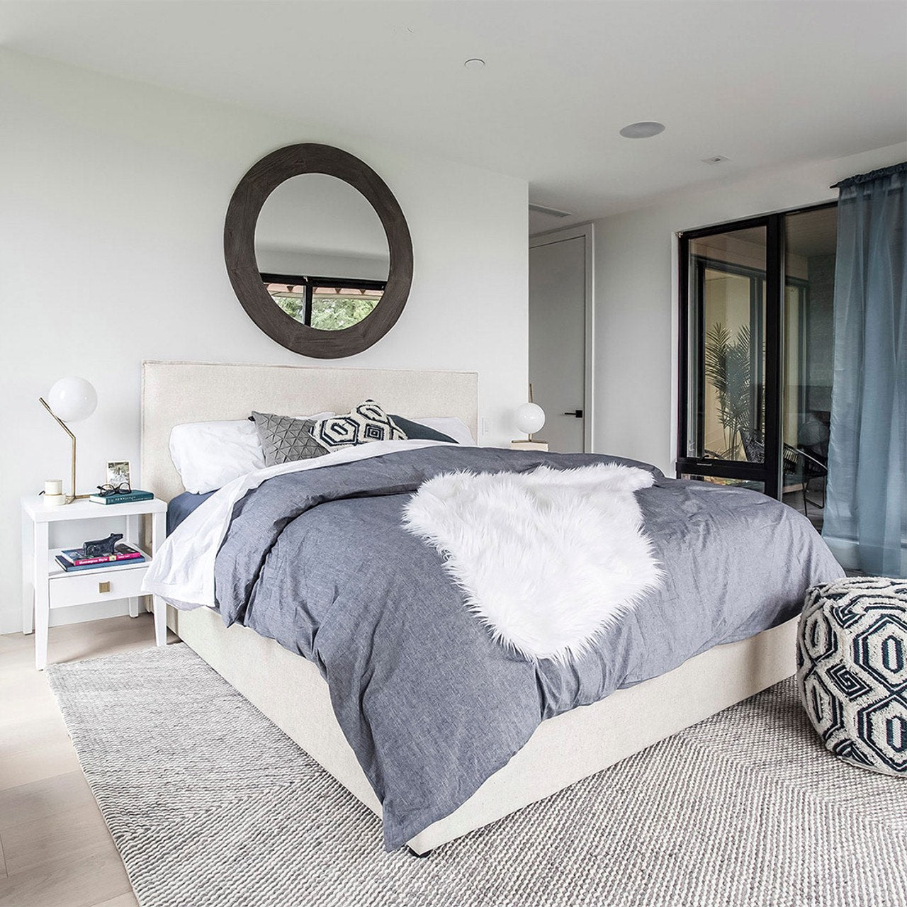 Modern bedroom with a bed, nightstands, and decorative pillows.