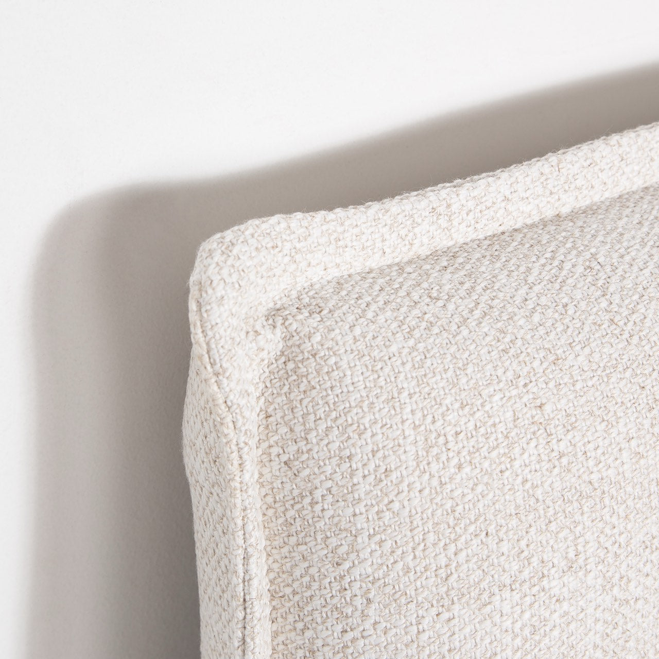 Close-up of a textured beige pillow on a light background