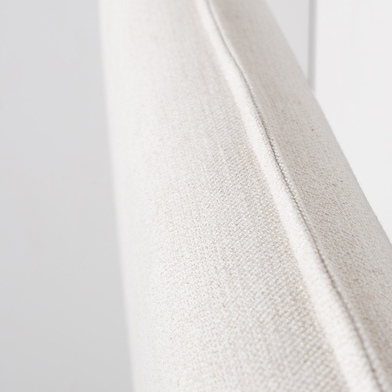 Close-up of a textured white fabric with a blurred background