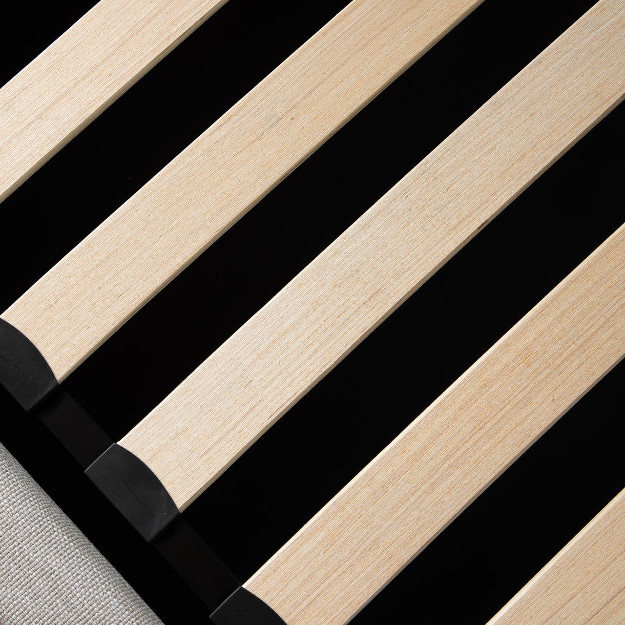Close-up of wooden slats with black edges on a black background