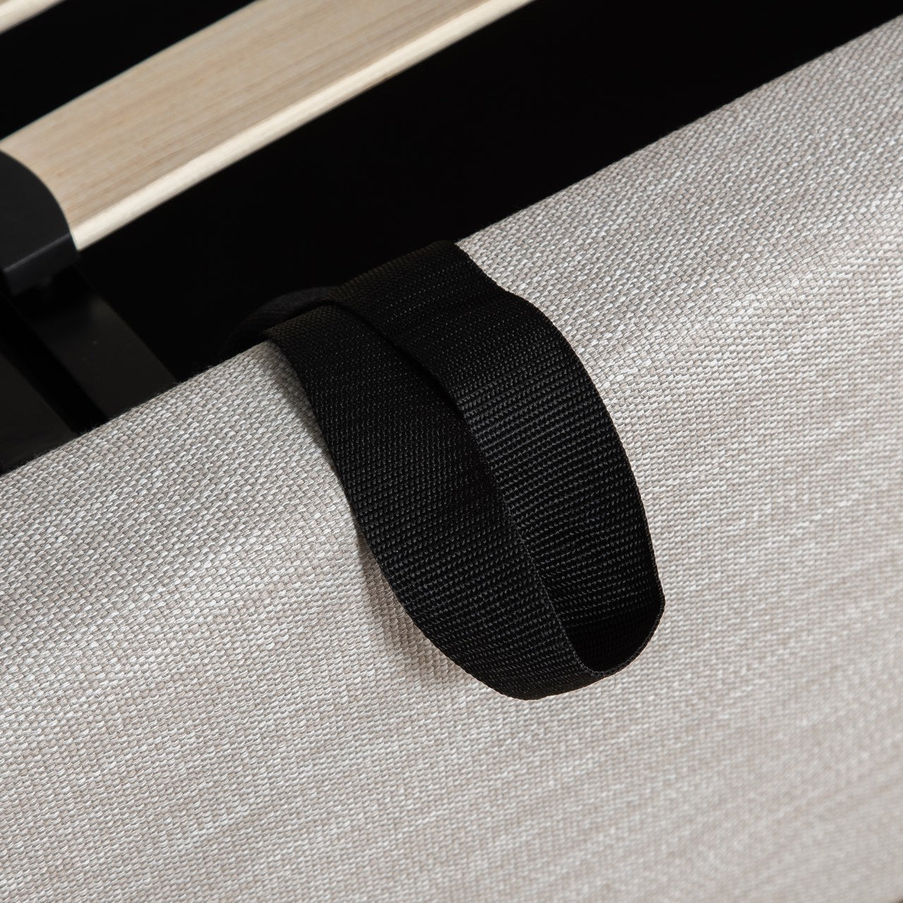 Black strap on a gray fabric surface