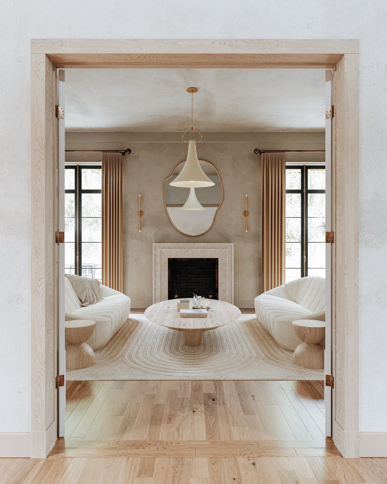 Keanu Wall Sconce styled in a curated living room for warm, layered light at Laurie Yapp Home.