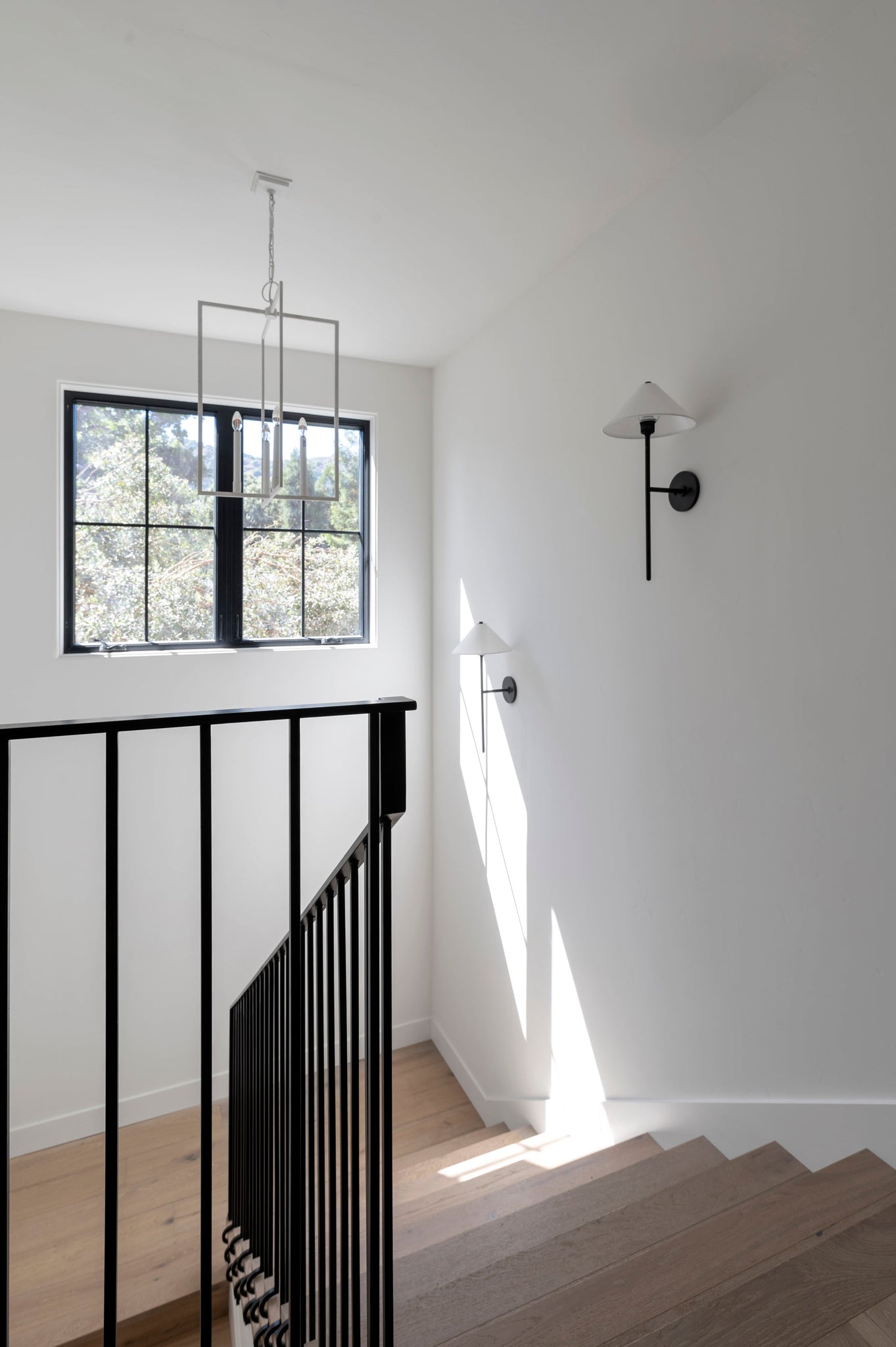 Cedar Wall Sconce styled in a warmly lit hallway for warm, layered light at Laurie Yapp Home.