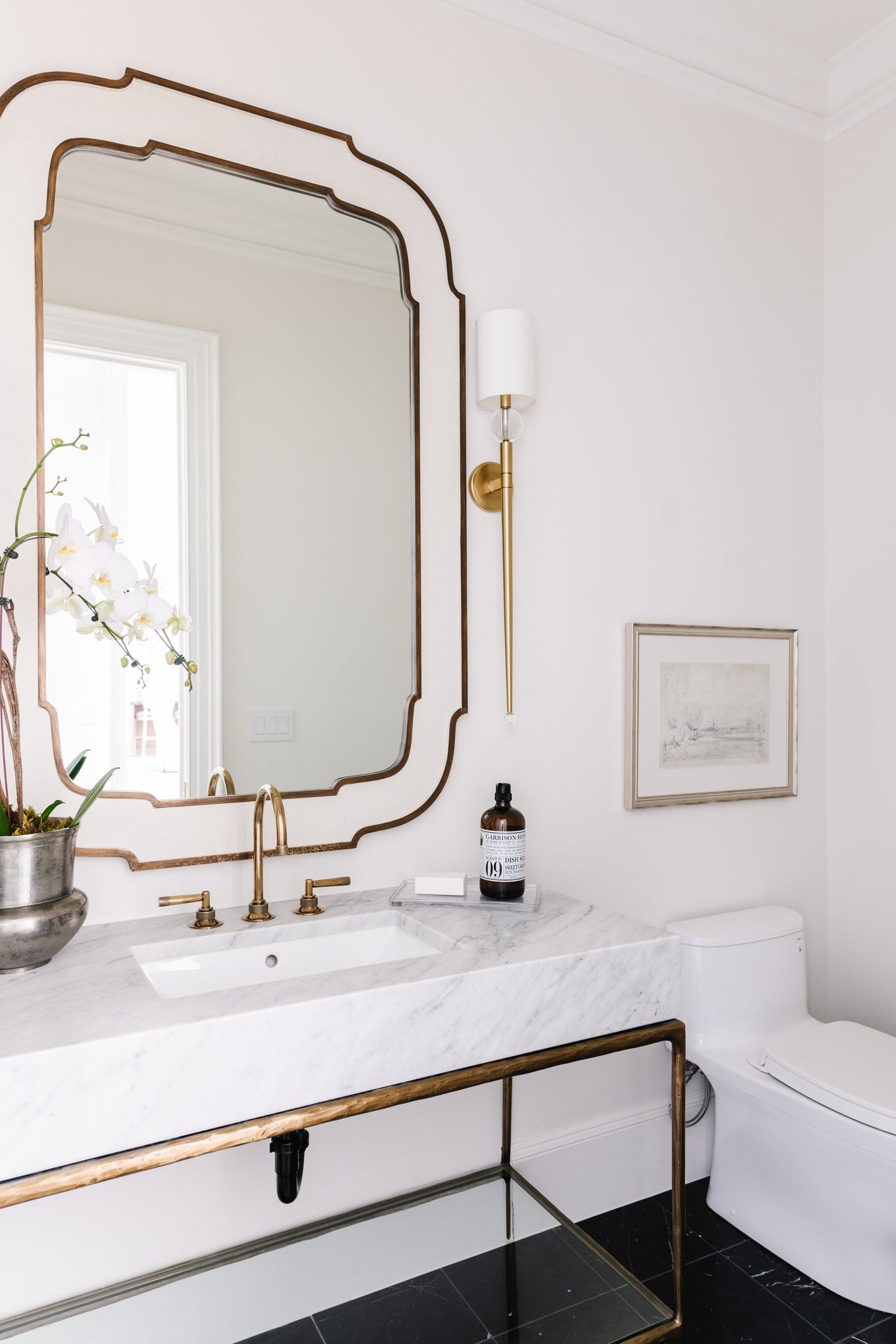 Rockland Wall Sconce 5.25" in aged brass styled in a curated living room for warm, layered light at Laurie Yapp Home.