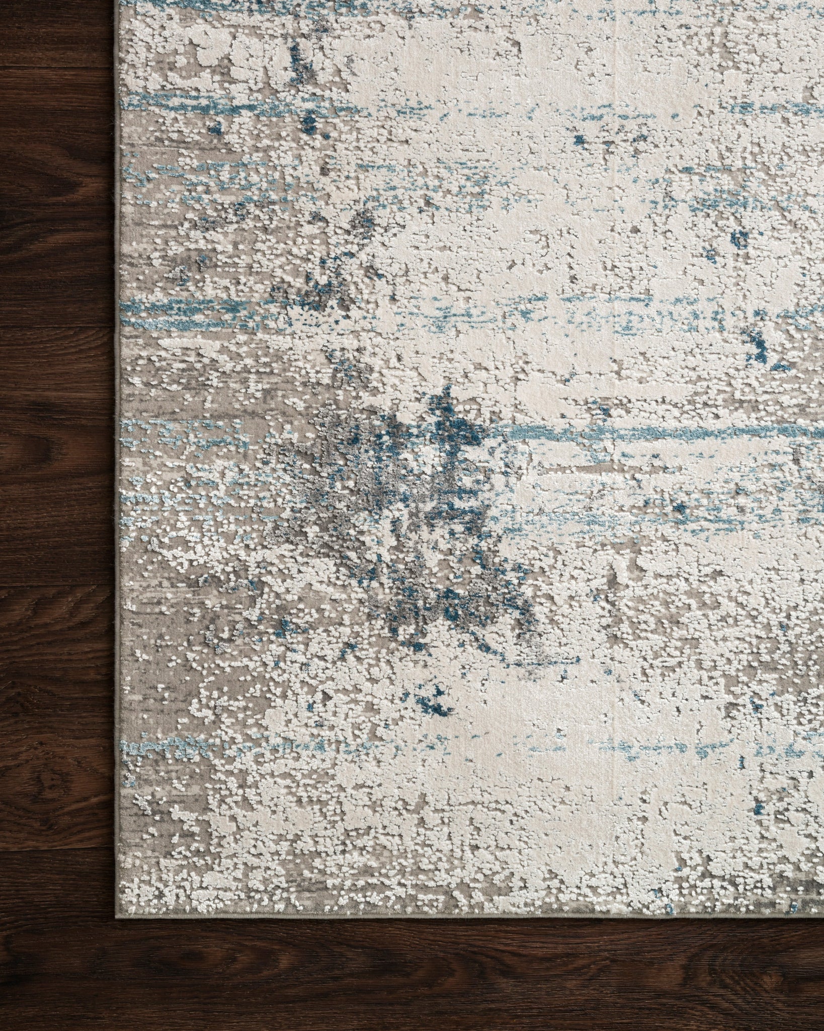 side view of Sienne Ivory / Ocean luxury Rug