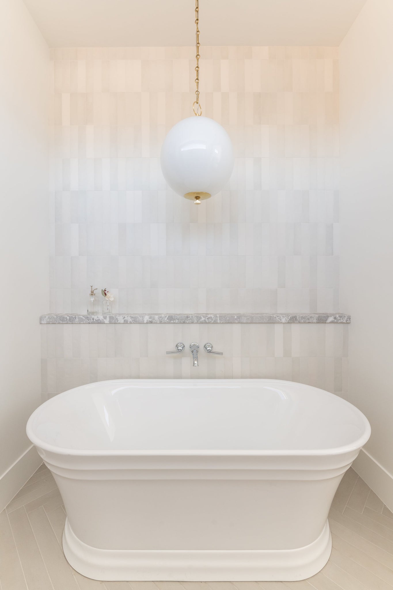 Sphere No.1 Pendant 16" in aged brass styled in a welcoming entryway for warm, layered light at Laurie Yapp Home.