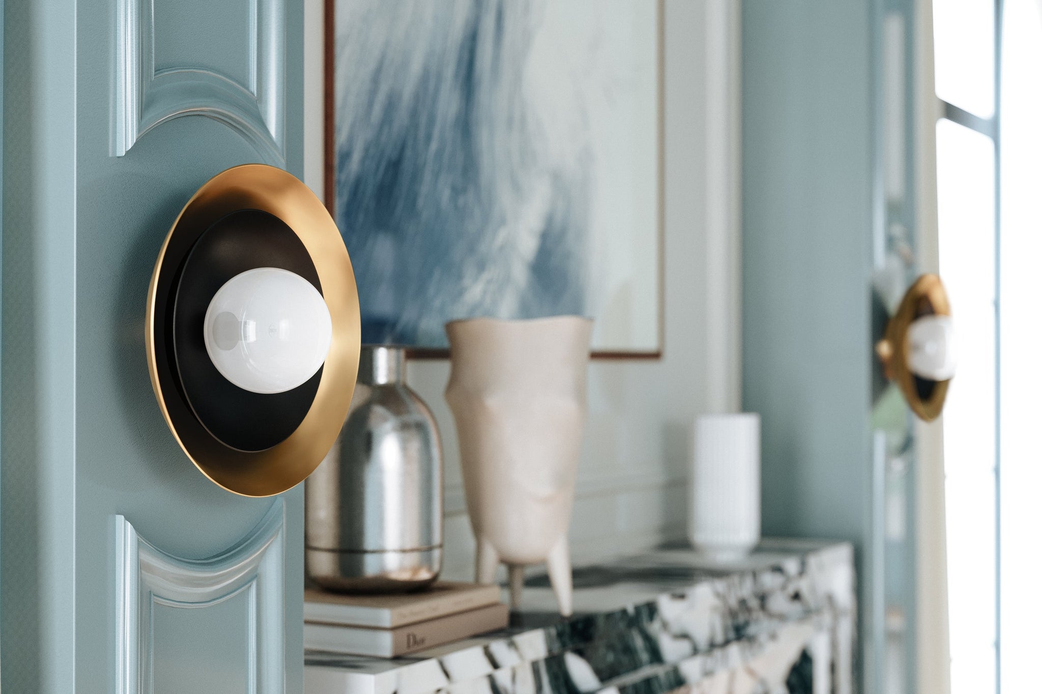 Close-up of the Tobia Wall Sconce showing the arm curve and shade silhouette.