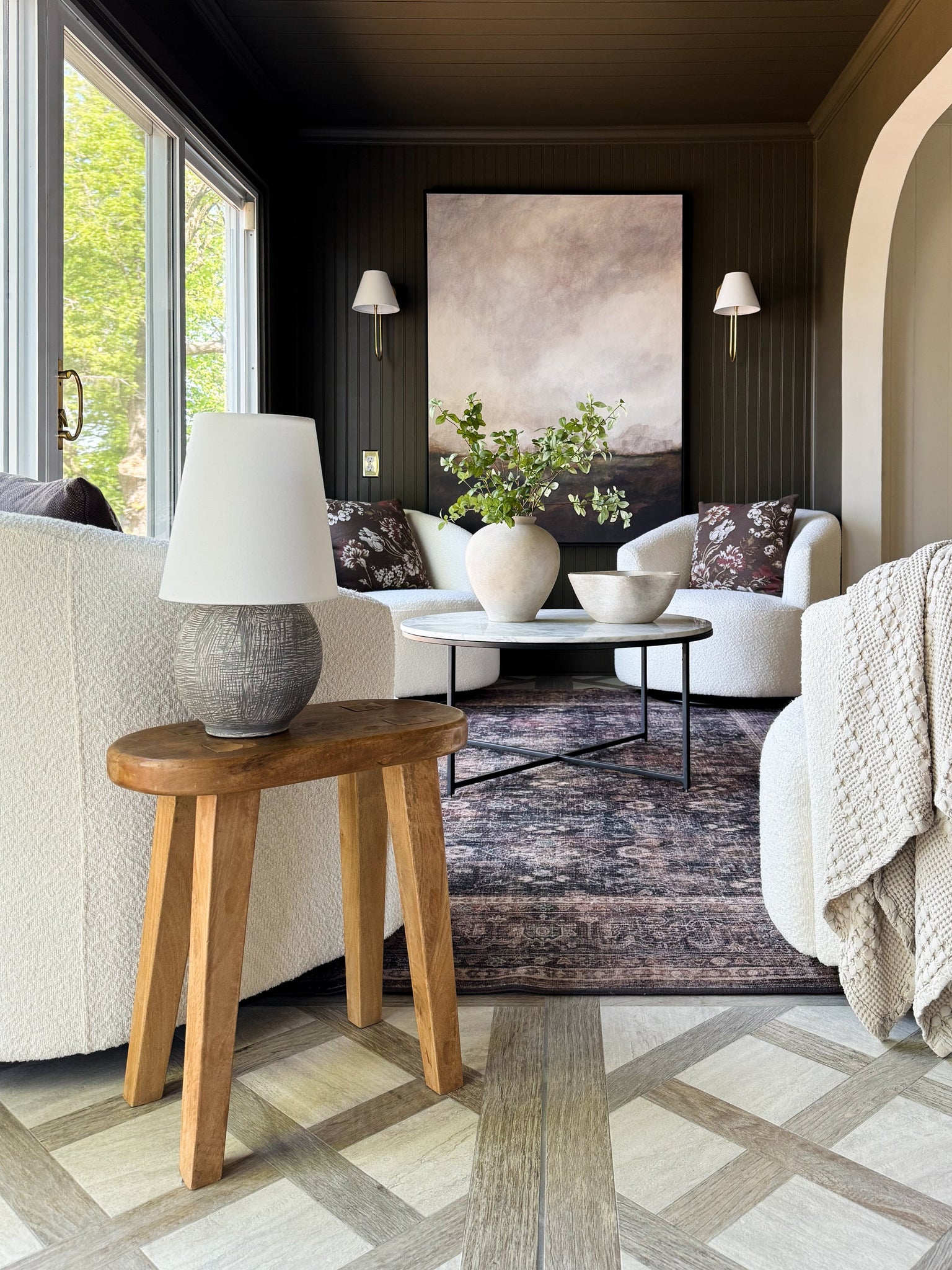 Hawthorne Wall Sconce in aged brass styled in a curated living room for warm, layered light at Laurie Yapp Home.