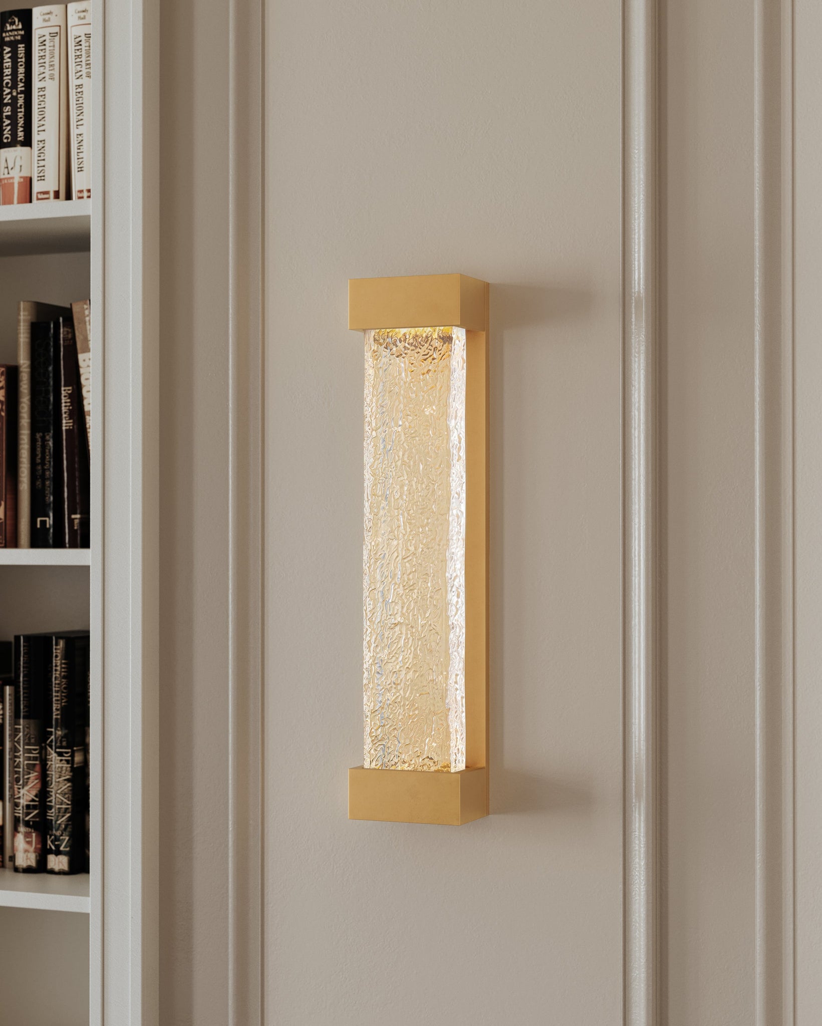 Close-up of the Wharton Wall Sconce 5" x 23" in aged brass showing the arm curve and shade silhouette.