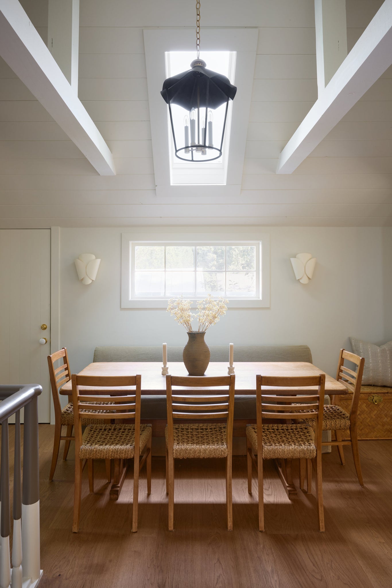 Savoie Wall Sconce in aged brass styled in a warmly lit hallway for warm, layered light at Laurie Yapp Home.