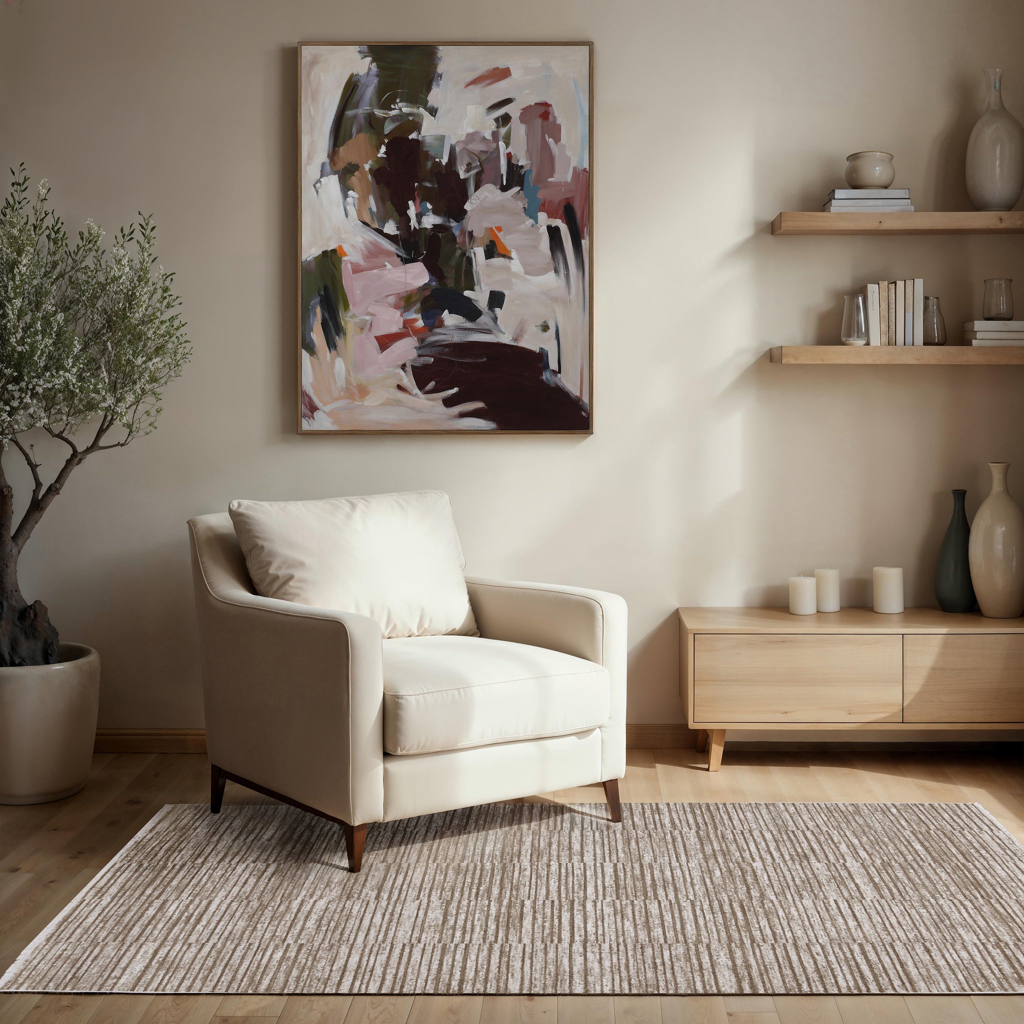 Blake rug by Renwil in beige, placed under a chair in a modern interior with artwork.