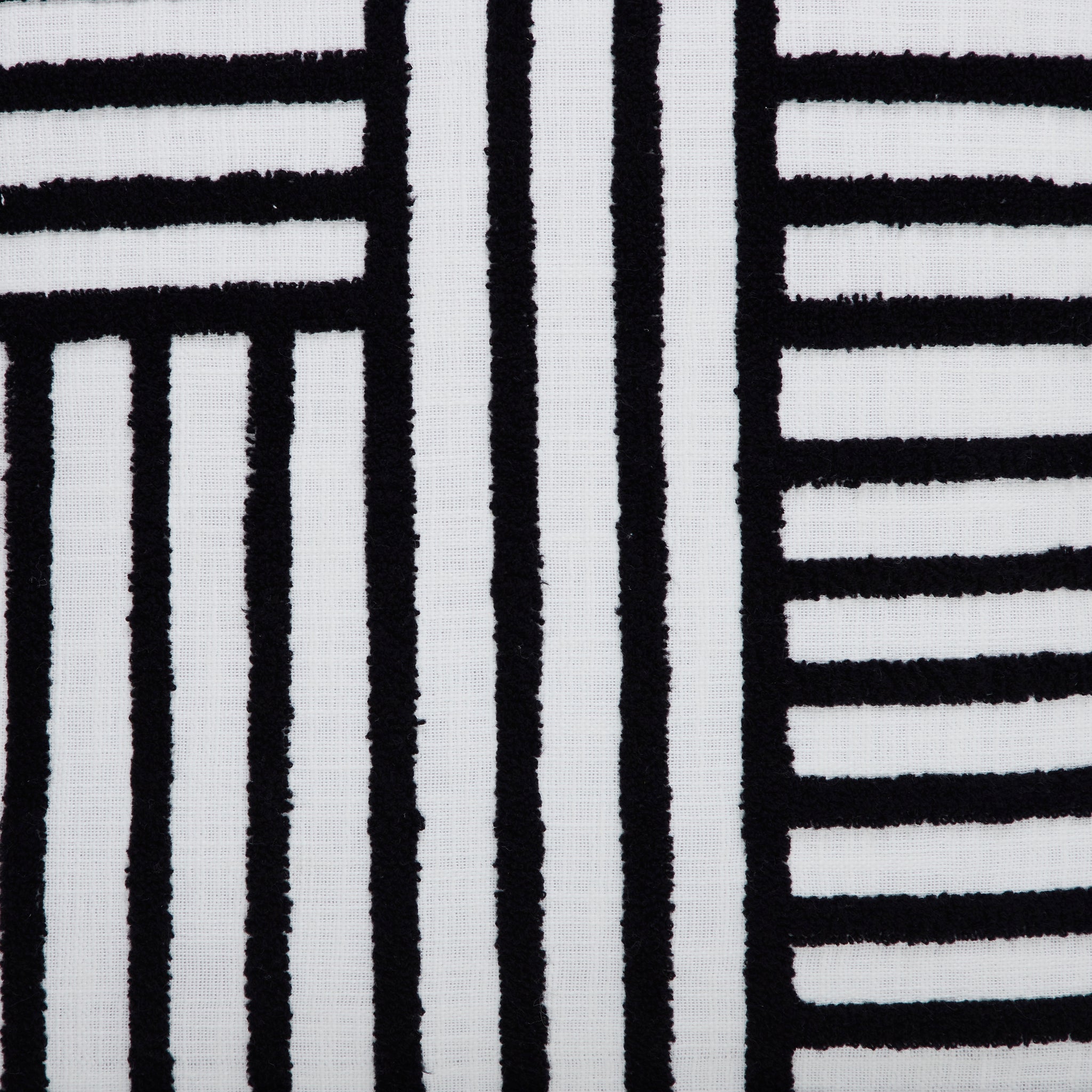 Close-up of Stilo indoor pillow showcasing the black and white striped texture.