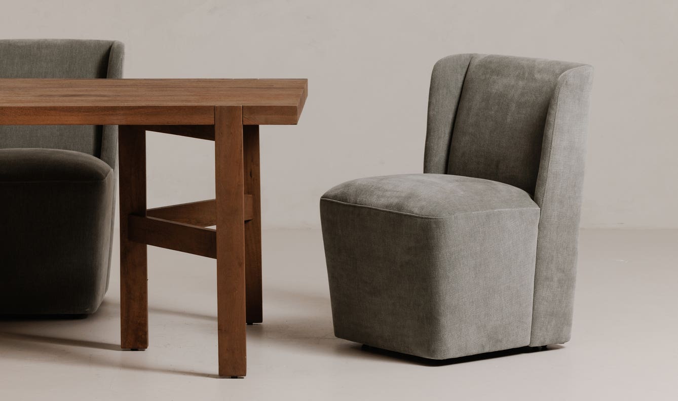 angle view of Cormac Rolling Dining Chair Performance Fabric Slate Green luxury Chair