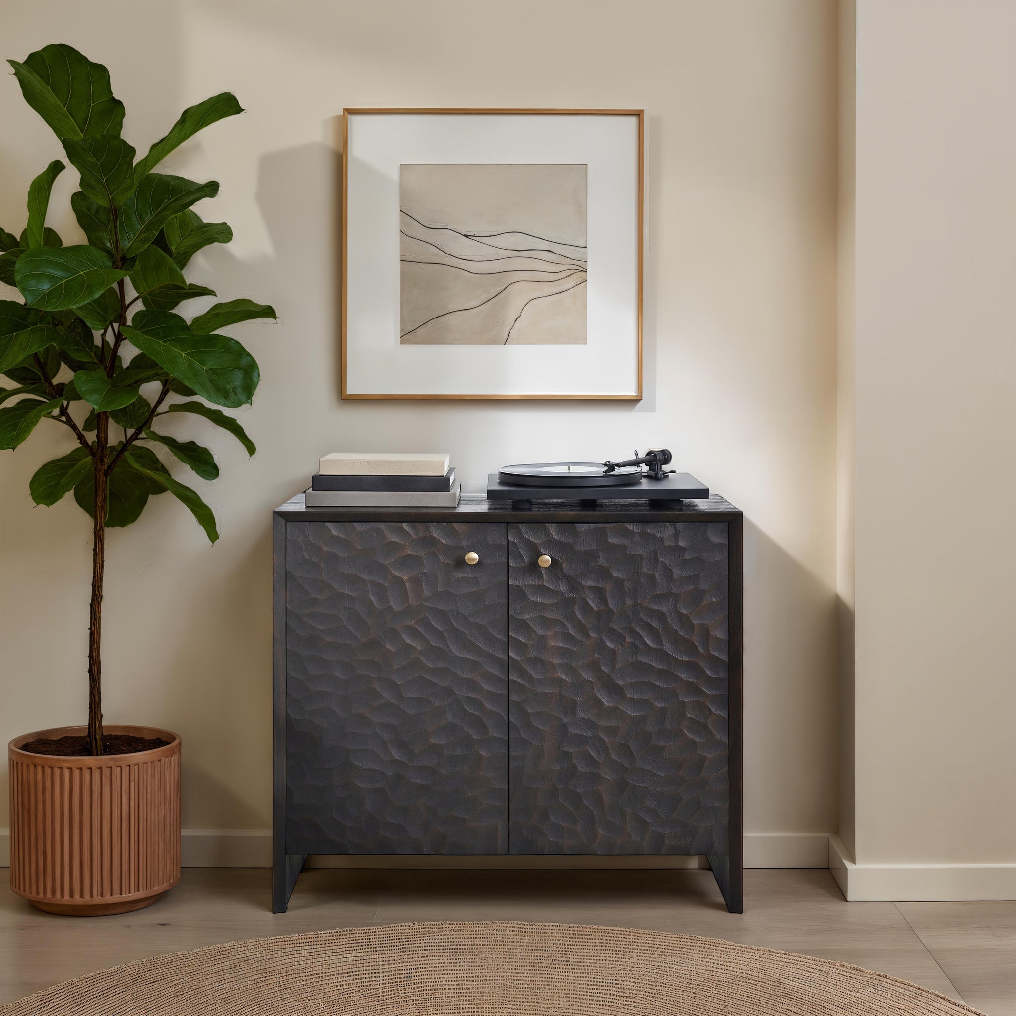 Jean Cabinet styled in a room with a plant, artwork, and a record player on top