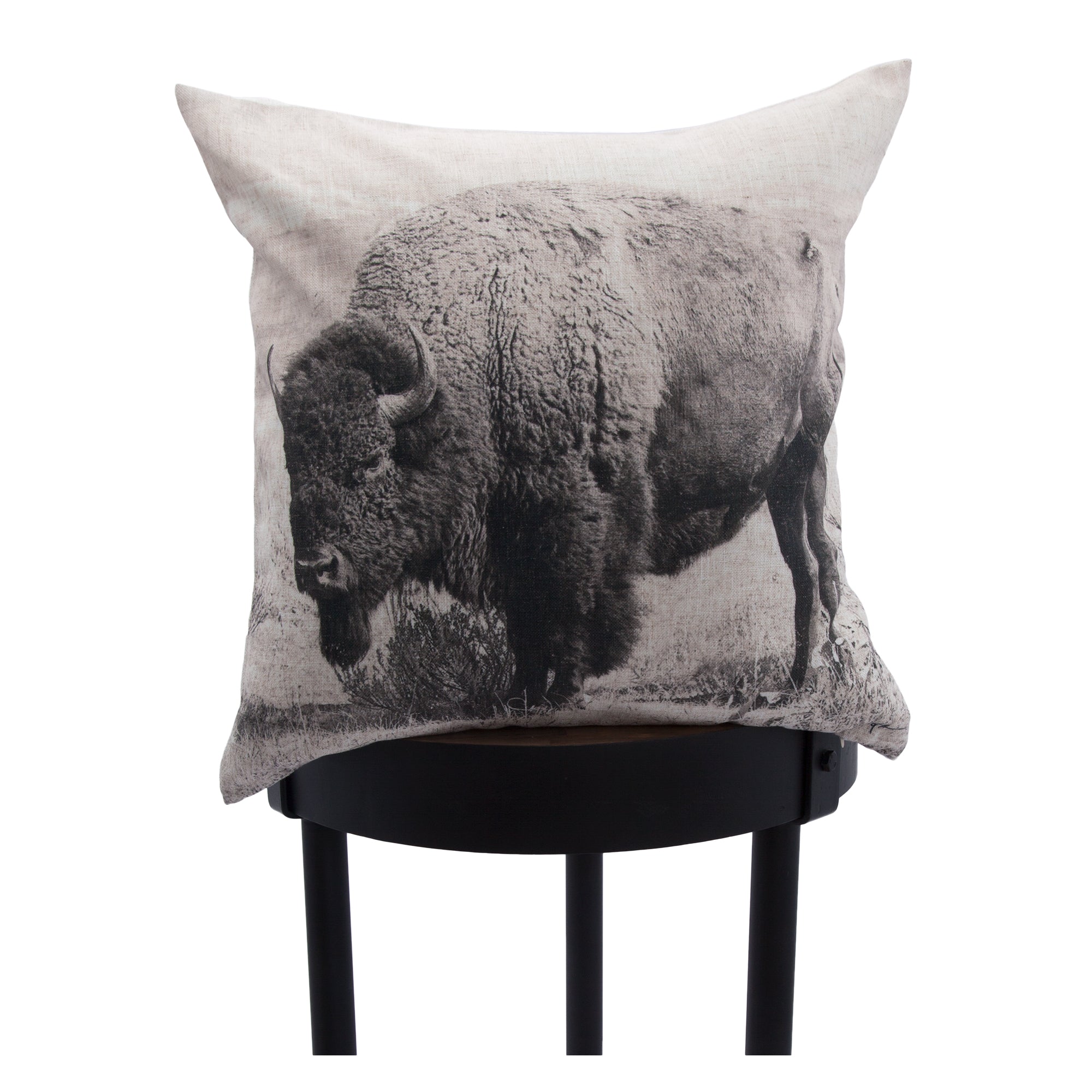 Russ indoor pillow with a buffalo design, displayed on a black stool for contrast.
