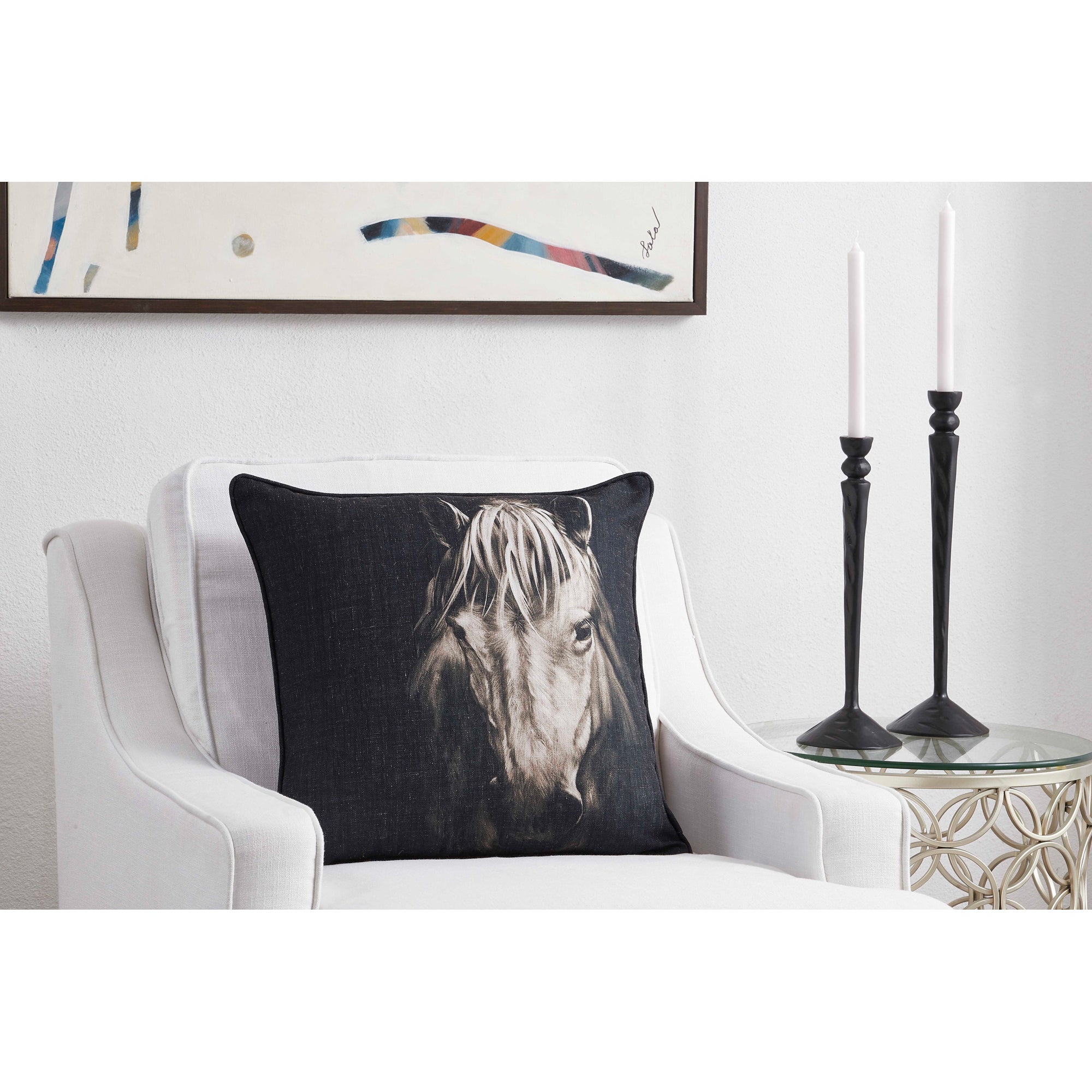 Del Rio Indoor Pillow on a white chair, showcasing a horse design