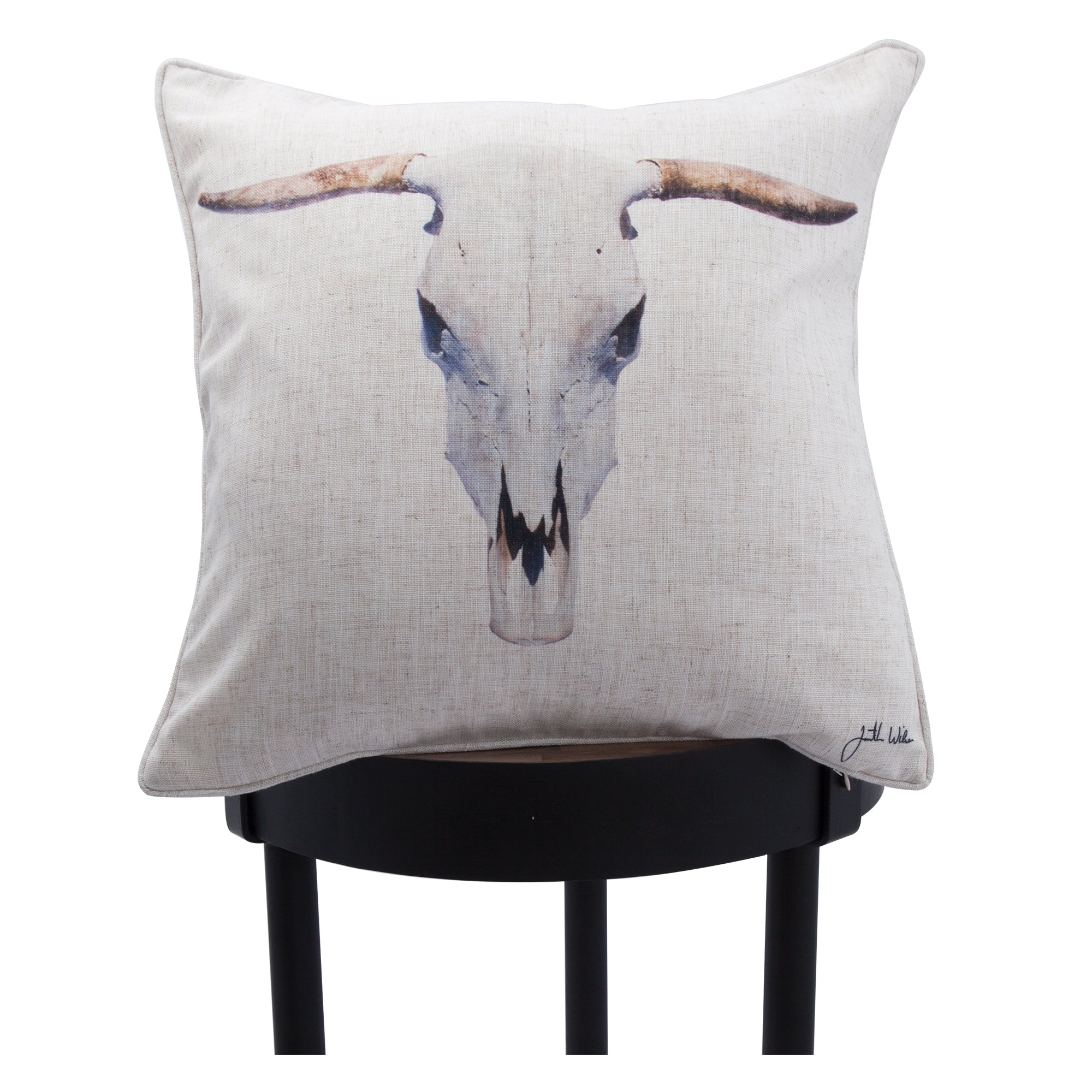 Elgin pillow showcasing a bull skull print, displayed on a black stool.