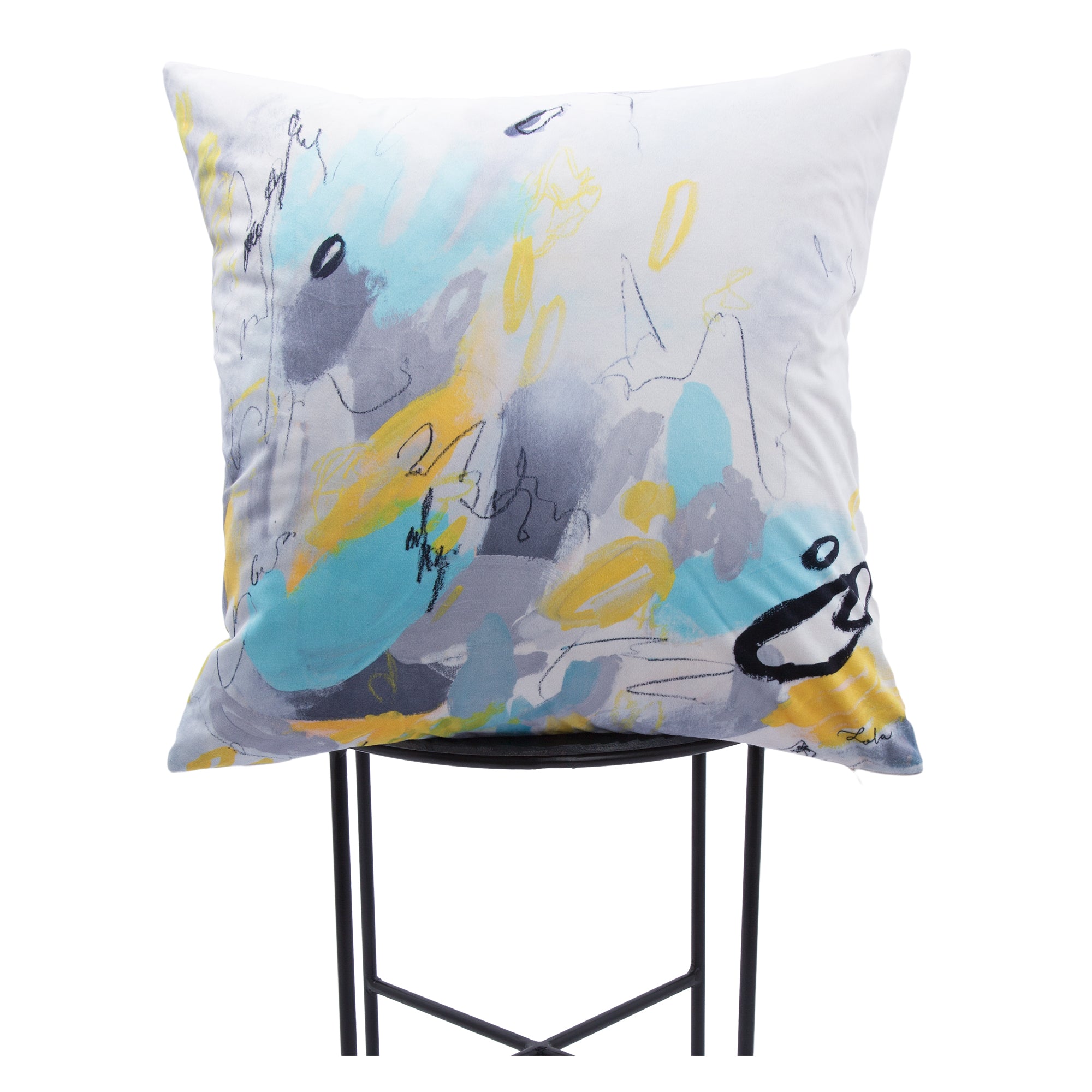 Faro indoor pillow featuring colorful abstract patterns in blue, gray, and yellow, displayed on a black metal stand.