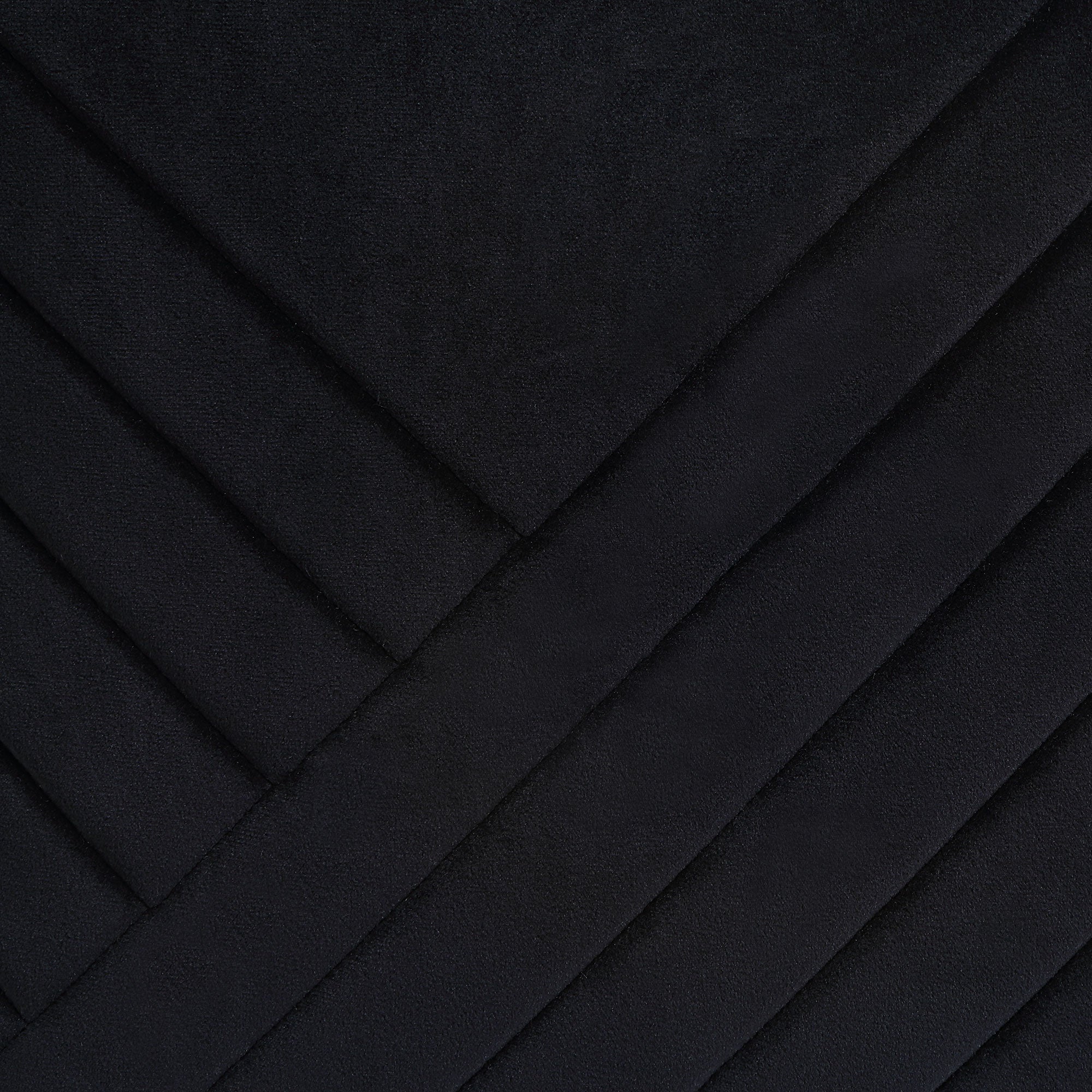 Close-up of Diran Indoor Pillow in black showcasing diagonal quilted texture