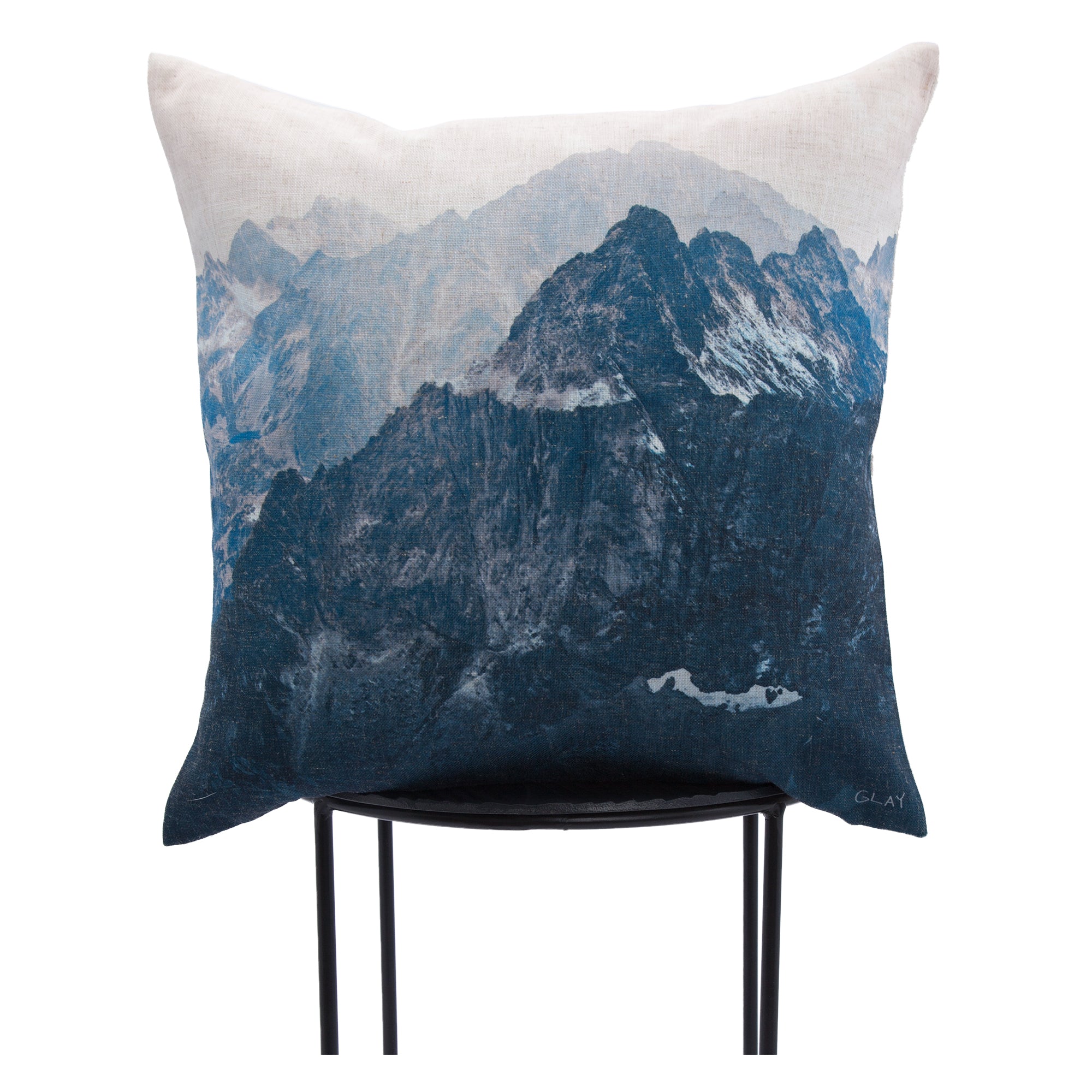 Irvine Indoor Pillow showcasing a mountain scene in blue and gray, displayed on a stand.