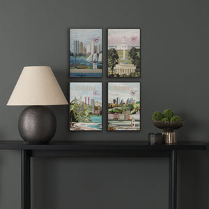 Four framed artworks on a dark wall above a black console table with decorative items.