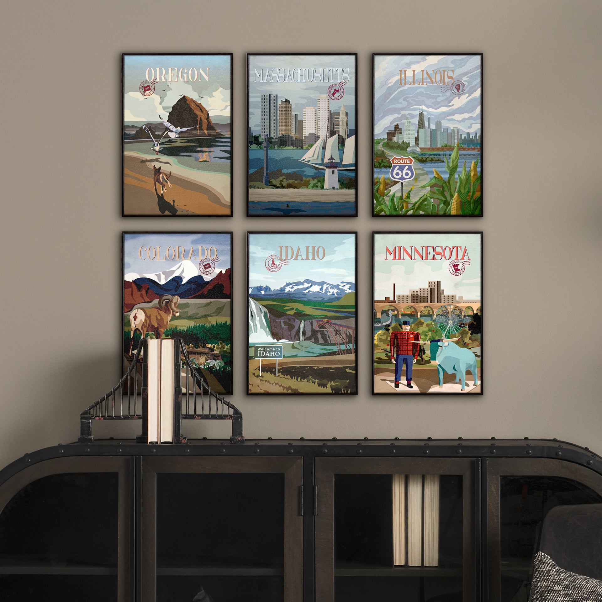 Set of framed posters of various U.S. states on a wall above a shelf.
