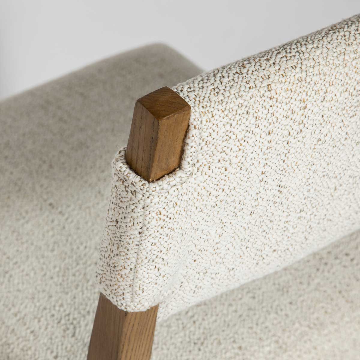 Chair with beige fabric seat and backrest on a white background