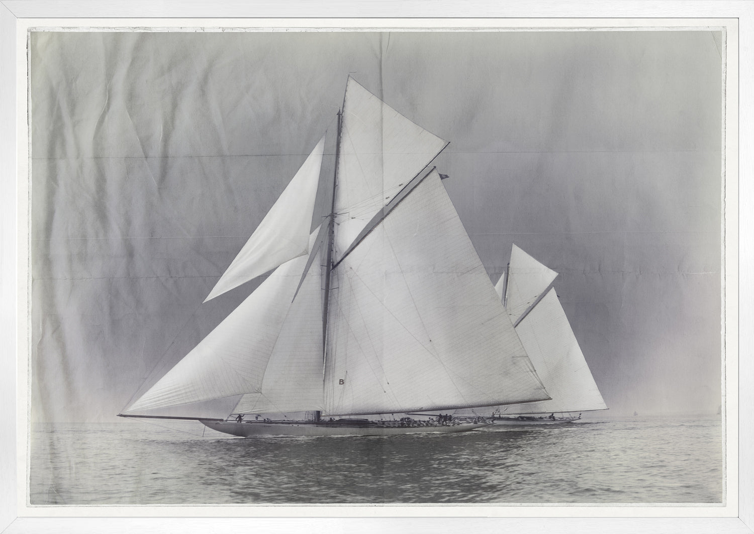Indigo Stained – Yachts Constitution & Columbia, featuring a vintage sailboat with large white sails on calm waters.