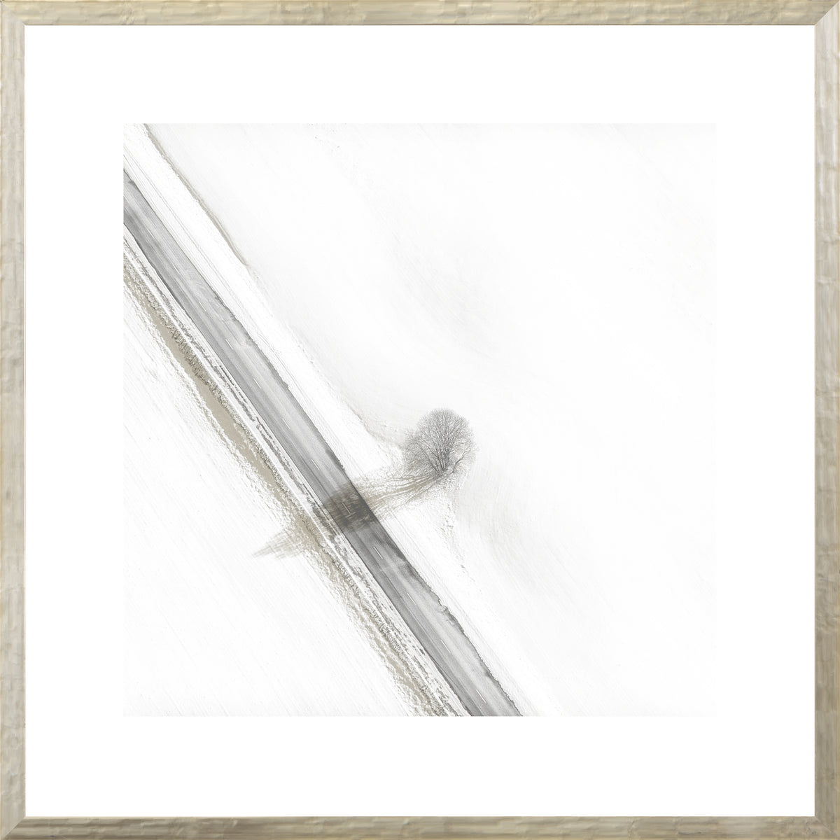 Aerial – Rural View V wall art featuring a snowy landscape with a tree and road.