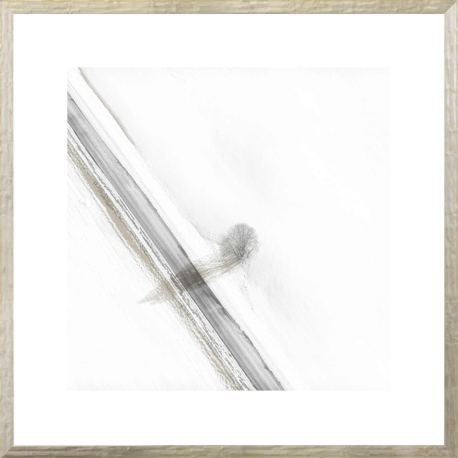 Aerial – Rural View V wall art featuring a snowy landscape with a tree and road.