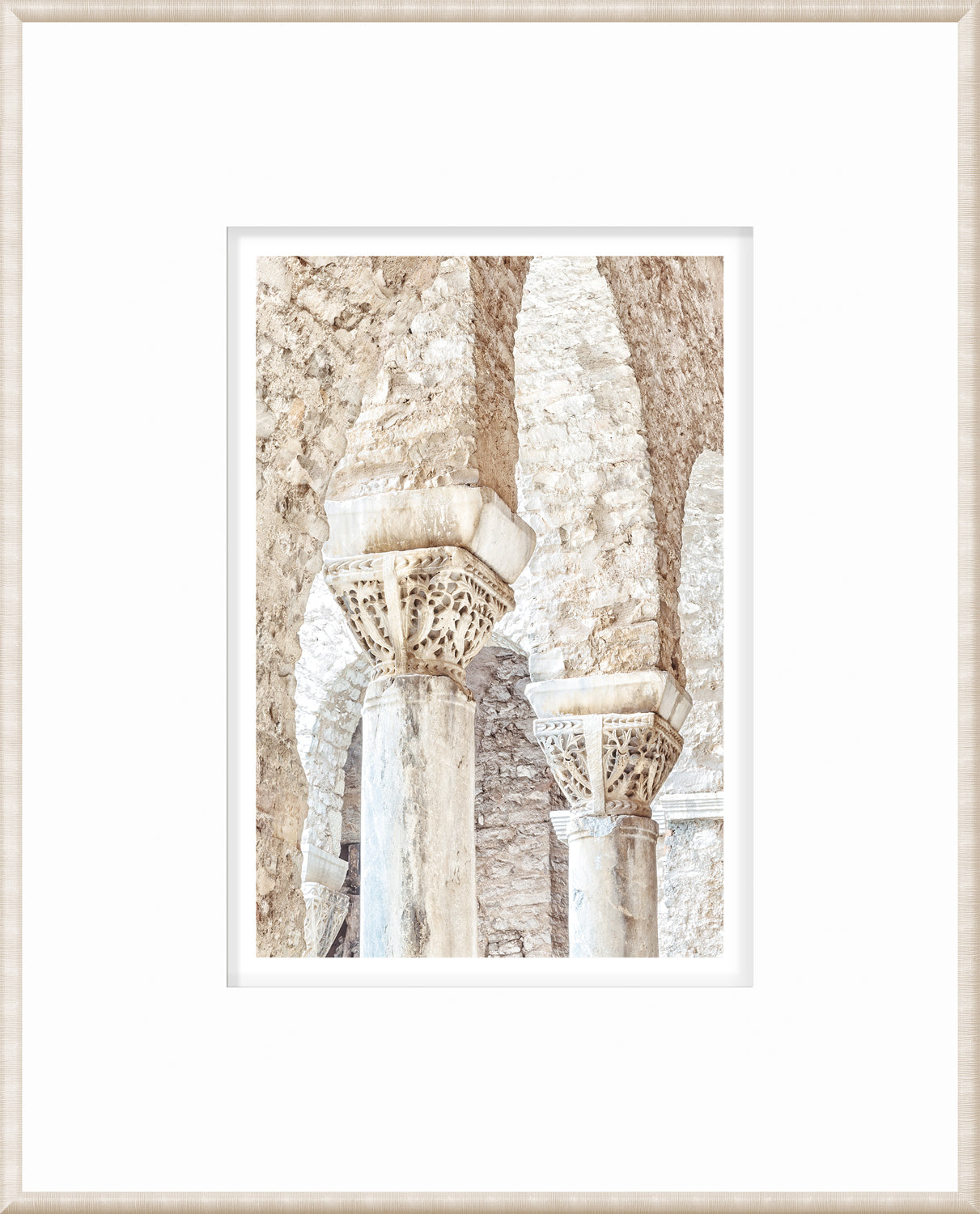 Masonry wall art featuring intricately carved stone columns in Porec, Croatia.