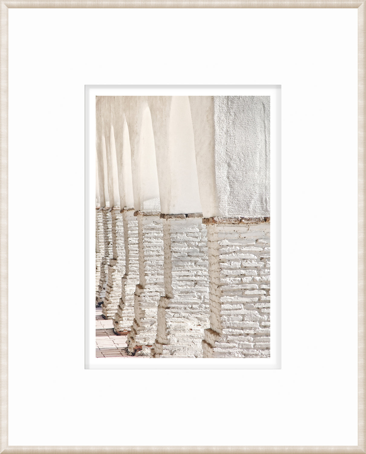 Masonry – Colonnade wall art featuring white arches and textured columns in a light setting.